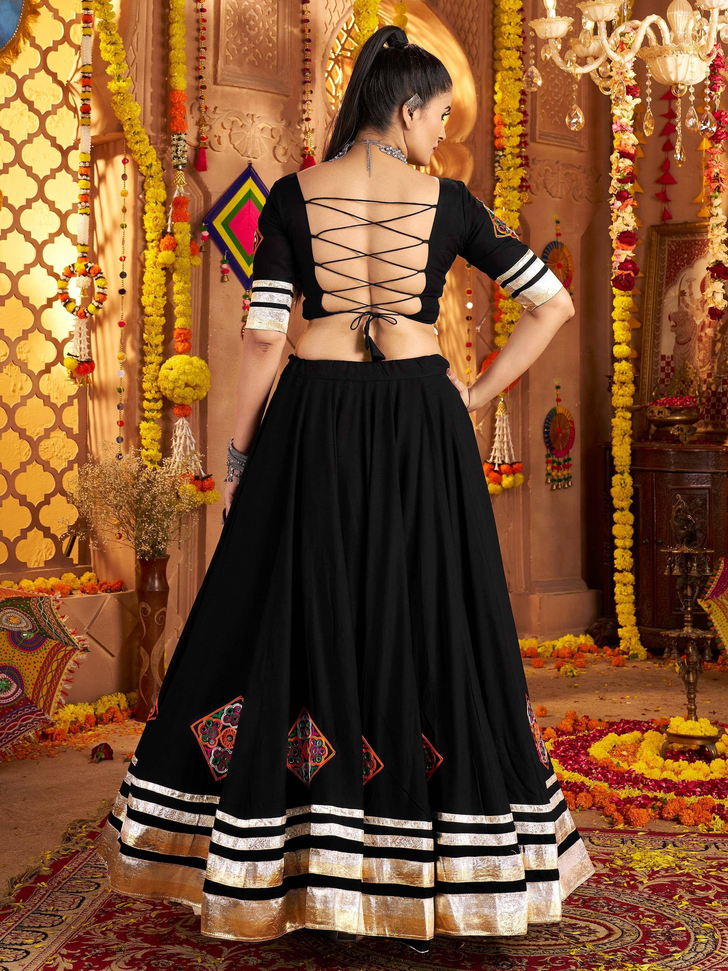 Black designer lehenga choli with crisscross back, ethnic embroidery, and gold border for festive occasions
