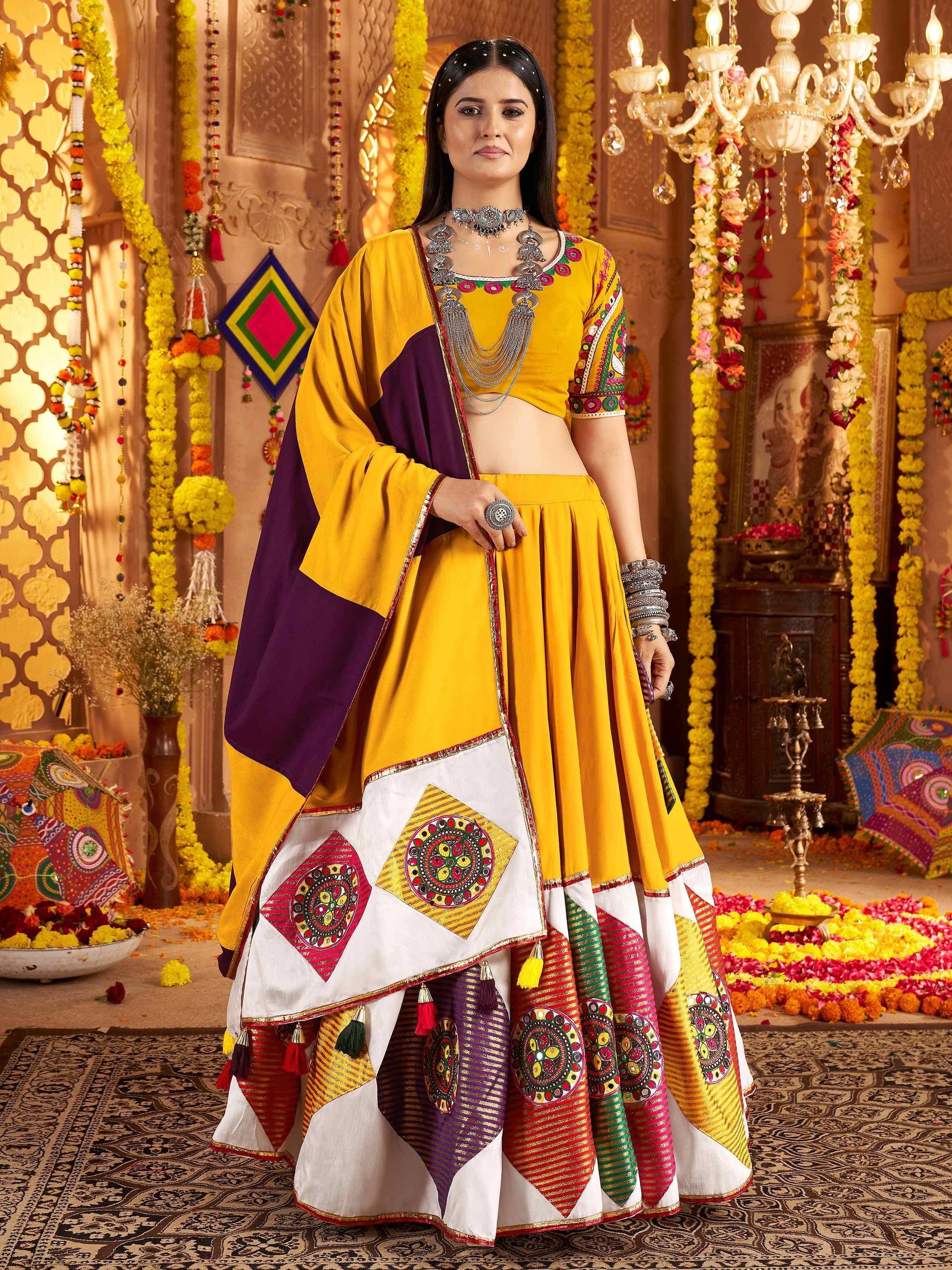 Yellow and purple embroidered lehenga choli with mirror work, perfect for Indian festivals and weddings