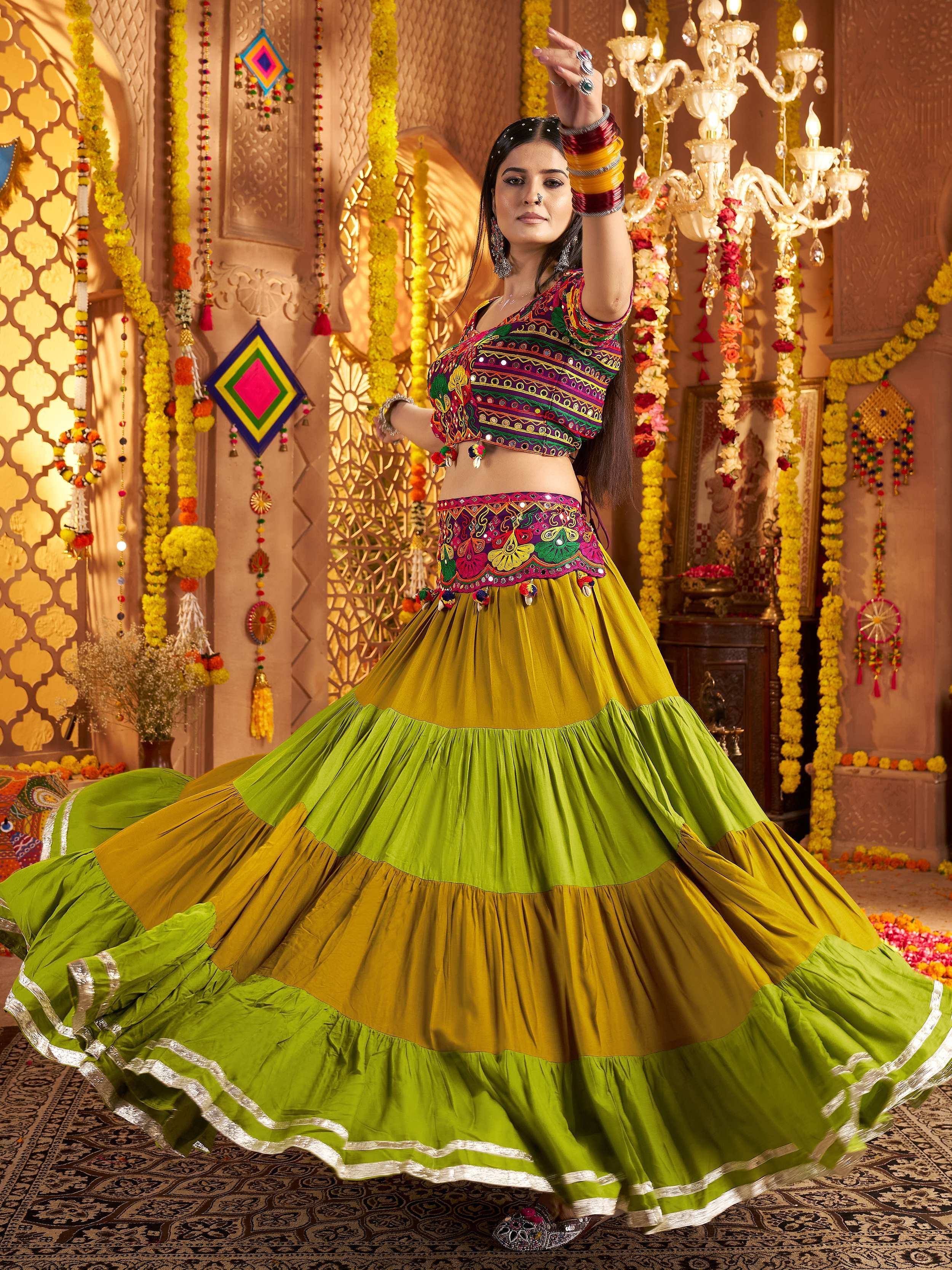 Woman in vibrant green and yellow embroidered lehenga choli, dancing in festive Indian decor