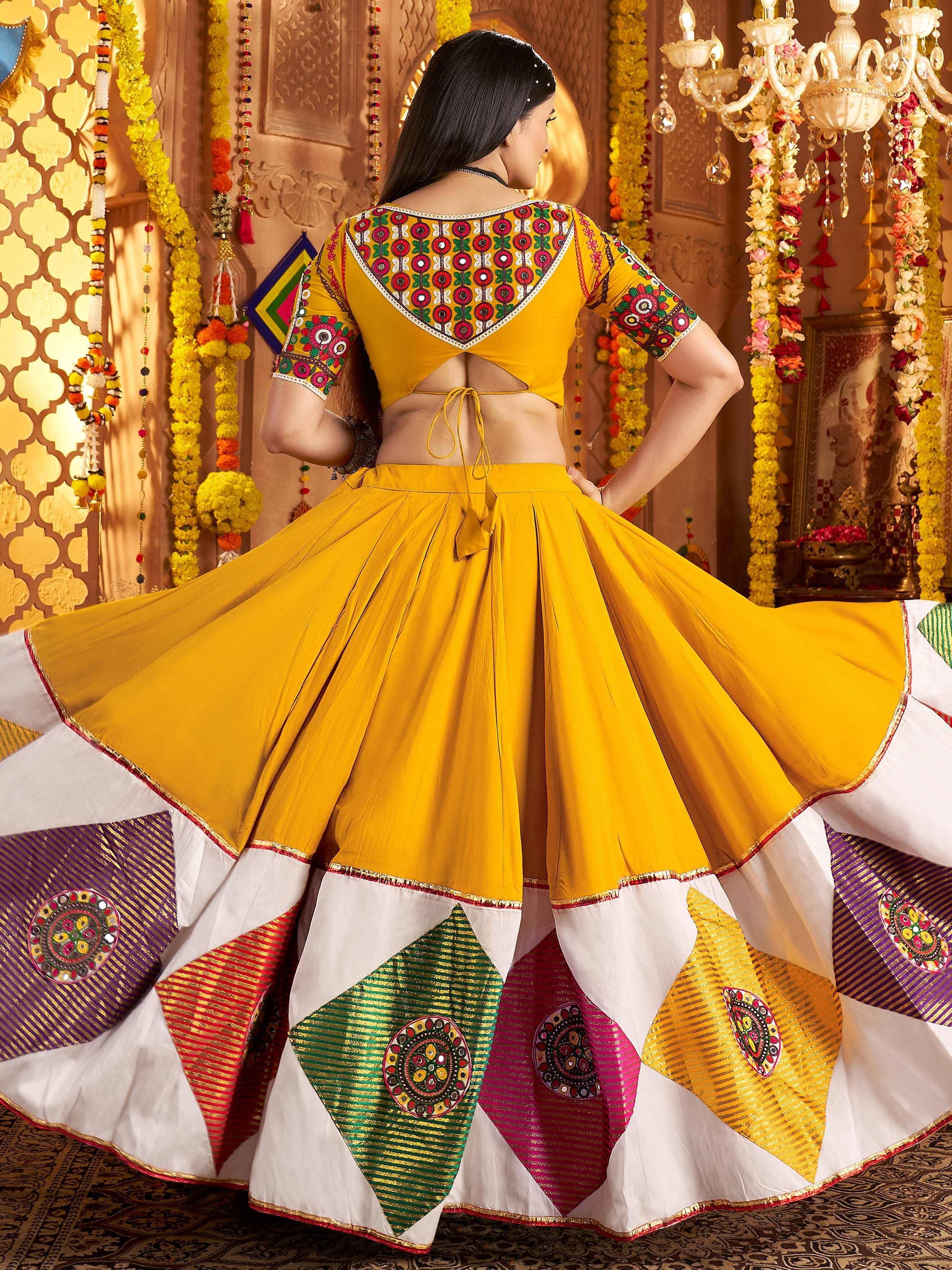 Yellow embroidered lehenga choli with colorful patchwork skirt, perfect for Indian ethnic wear and festive occasions.