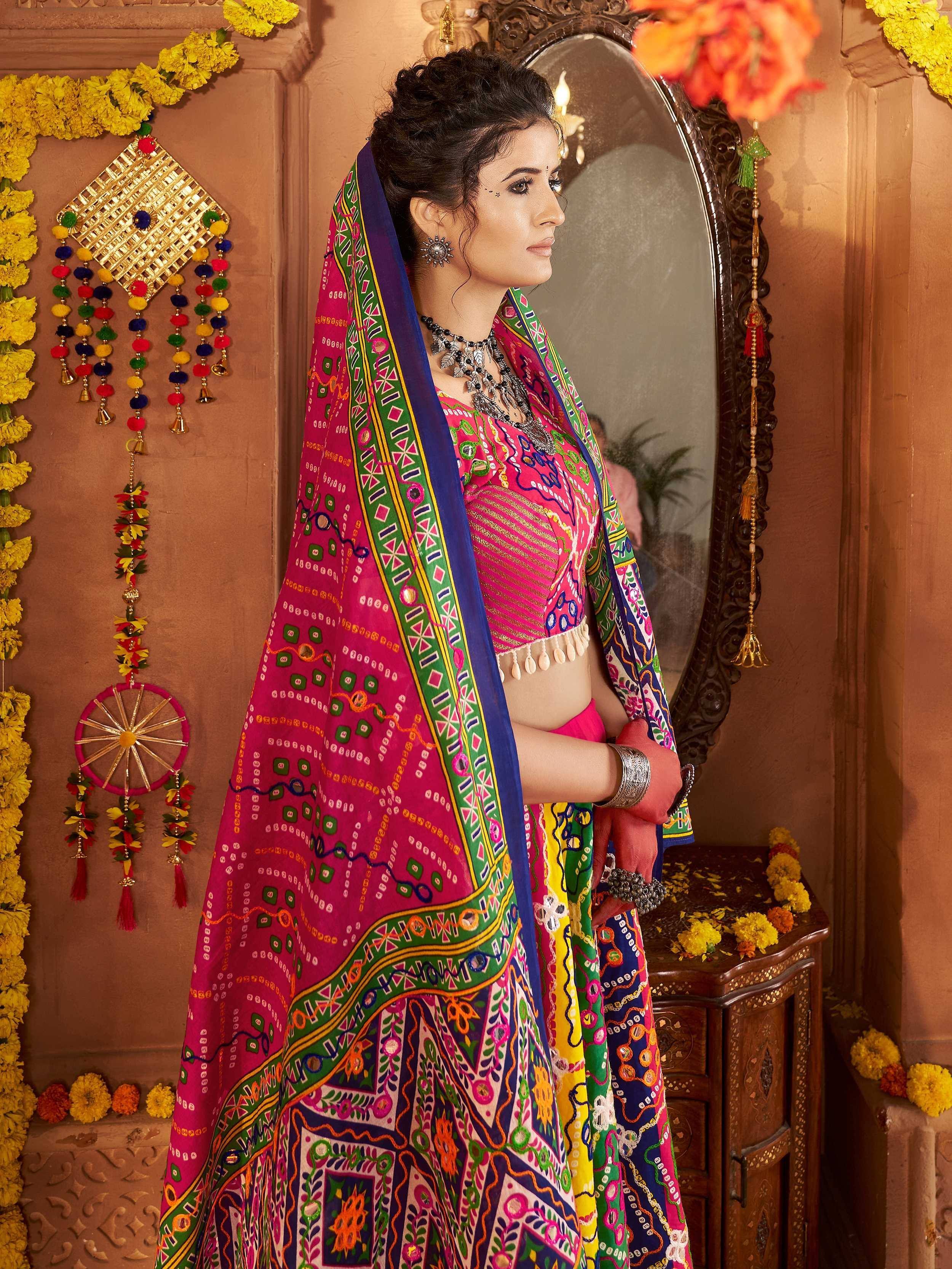 Vibrant pink and multicolor embroidered lehenga choli with mirror work, traditional Indian ethnic wear for festive occasions