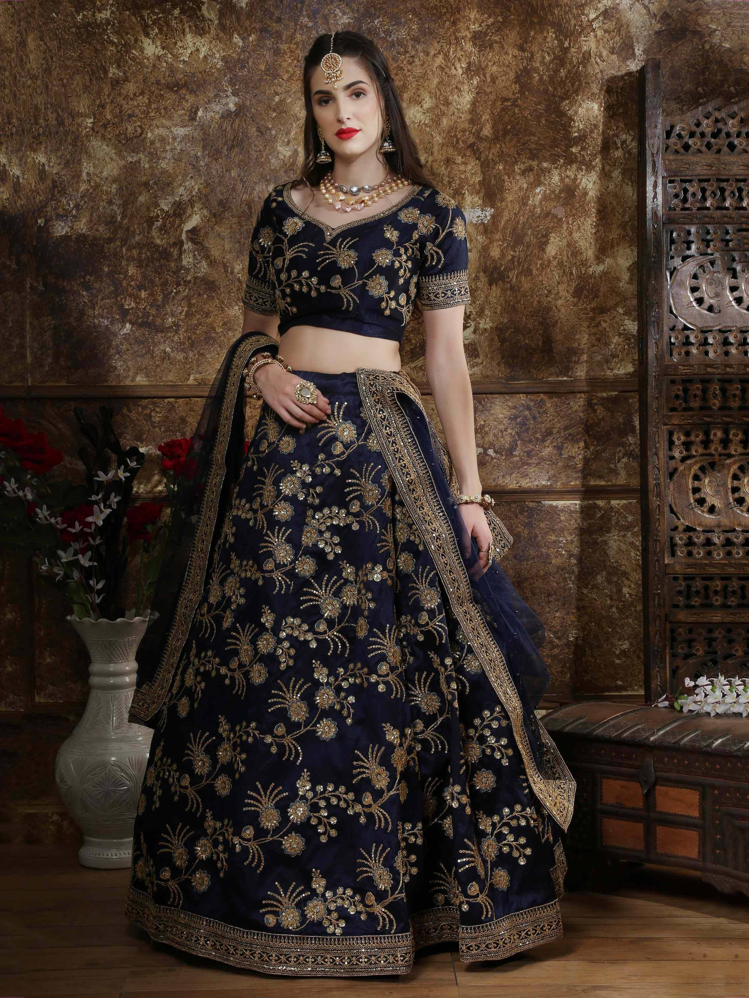 Navy blue designer lehenga choli with gold floral embroidery, perfect for Indian weddings and festive occasions.