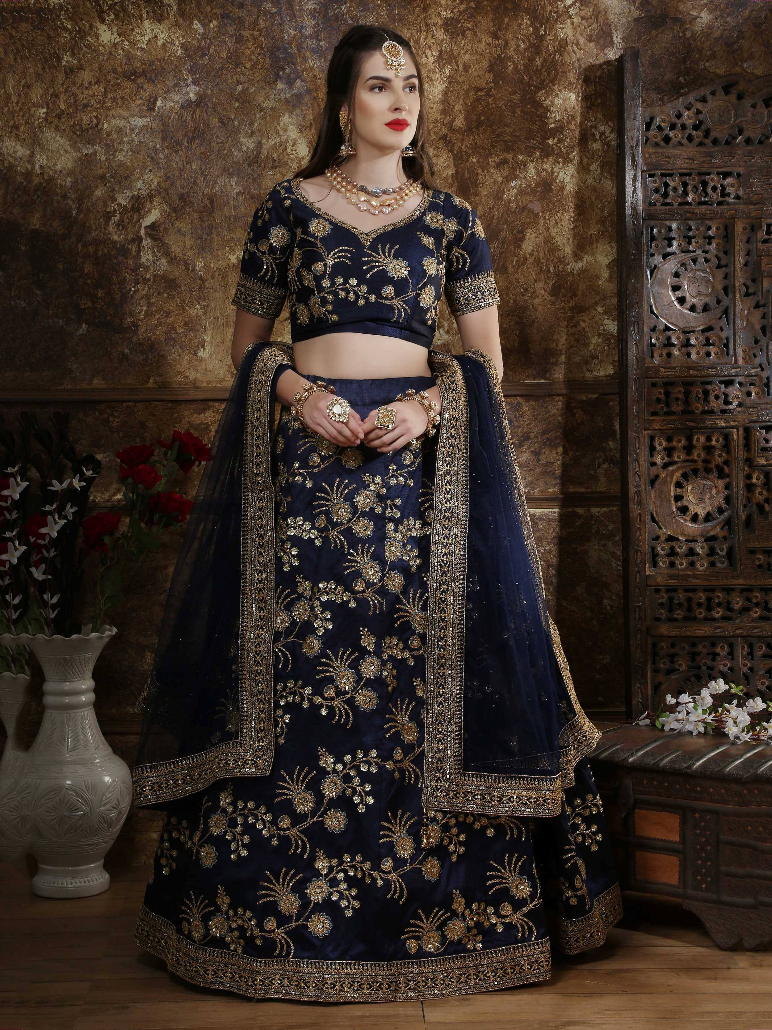Navy blue embroidered lehenga choli with gold floral work, perfect for Indian weddings and festive occasions.