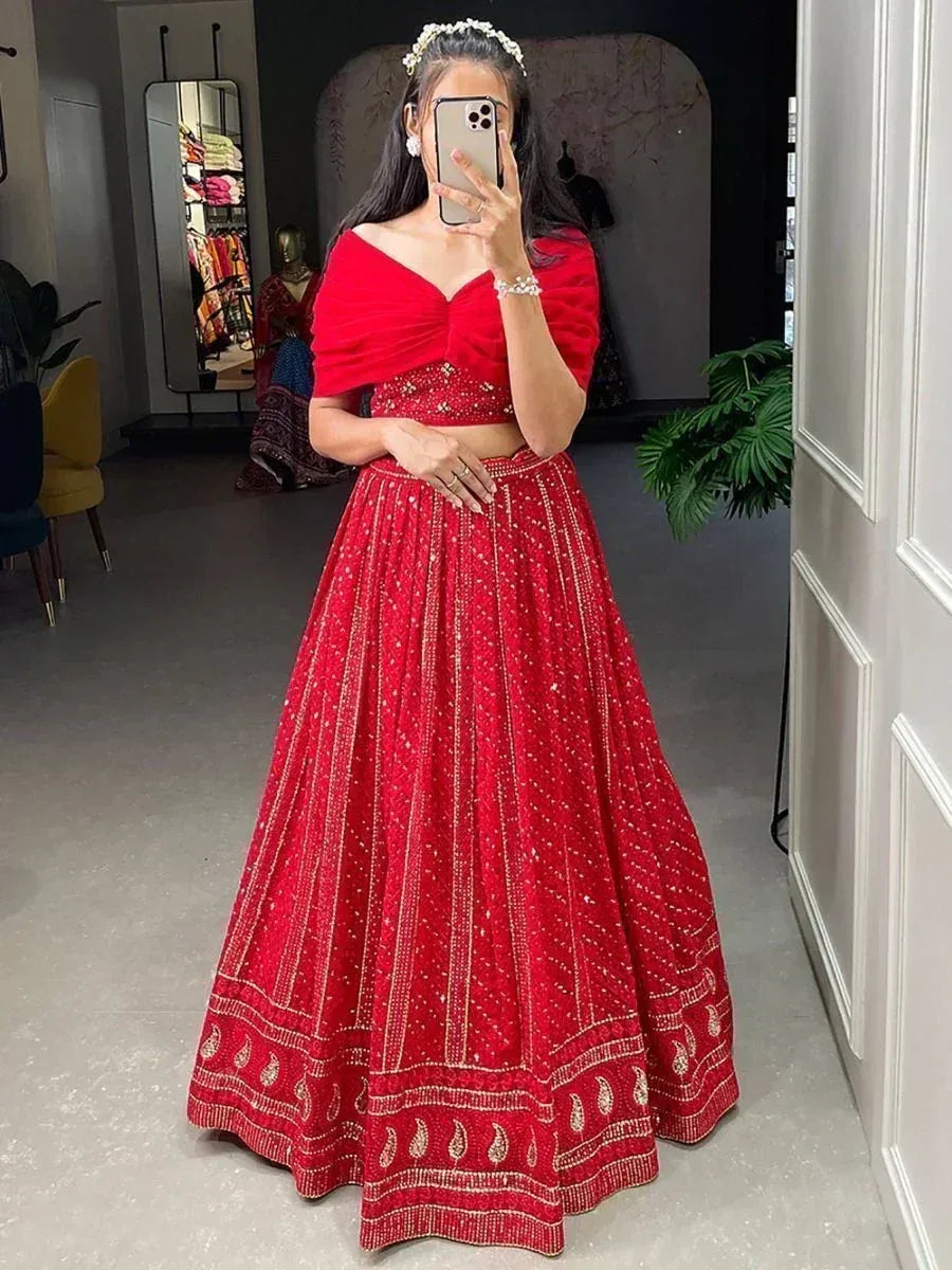 Red embroidered lehenga choli with off-shoulder blouse, perfect for Indian weddings and festive occasions