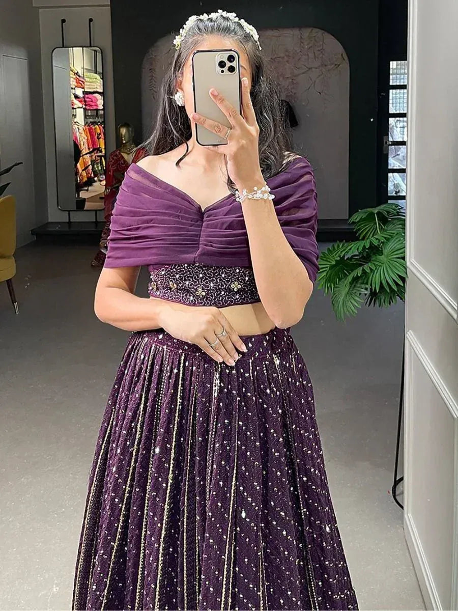 Purple designer lehenga choli with off-shoulder blouse and sequin skirt, perfect for Indian ethnic wear