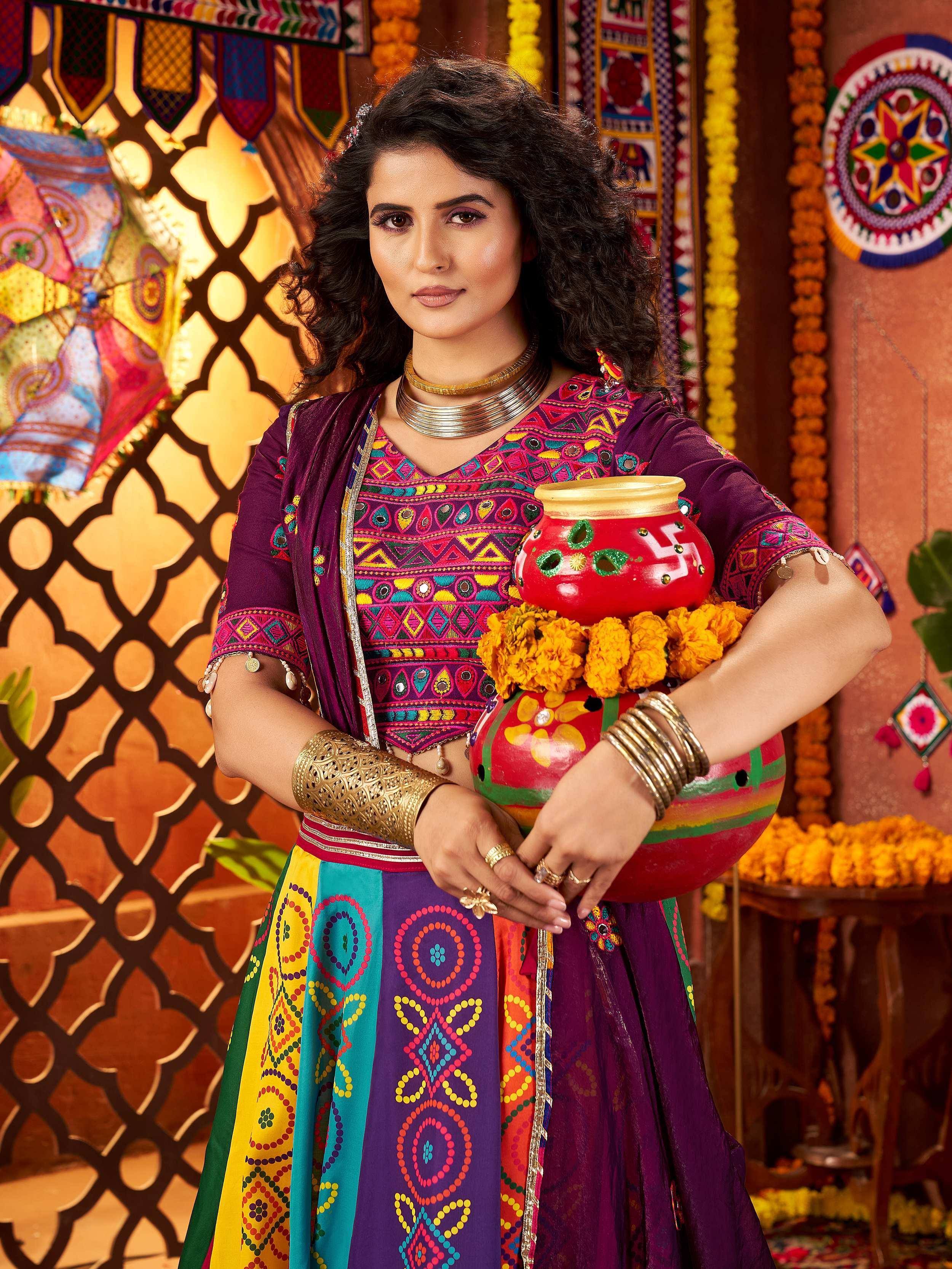 Woman in vibrant Indian ethnic wear with embroidered choli and colorful skirt, holding decorative pot, festive backdrop