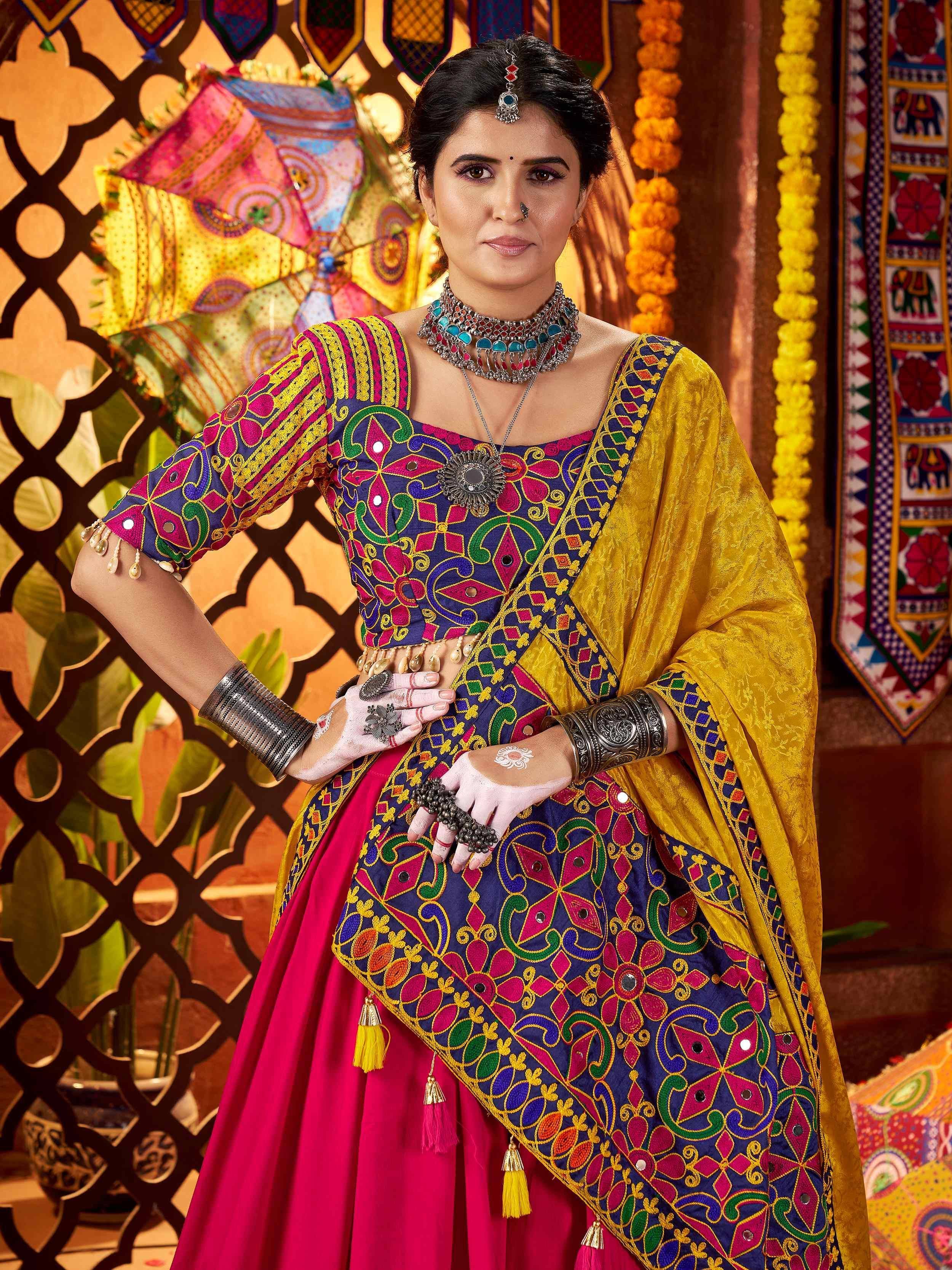 Woman in vibrant Indian ethnic wear with mirror work, colorful lehenga choli, and traditional jewelry