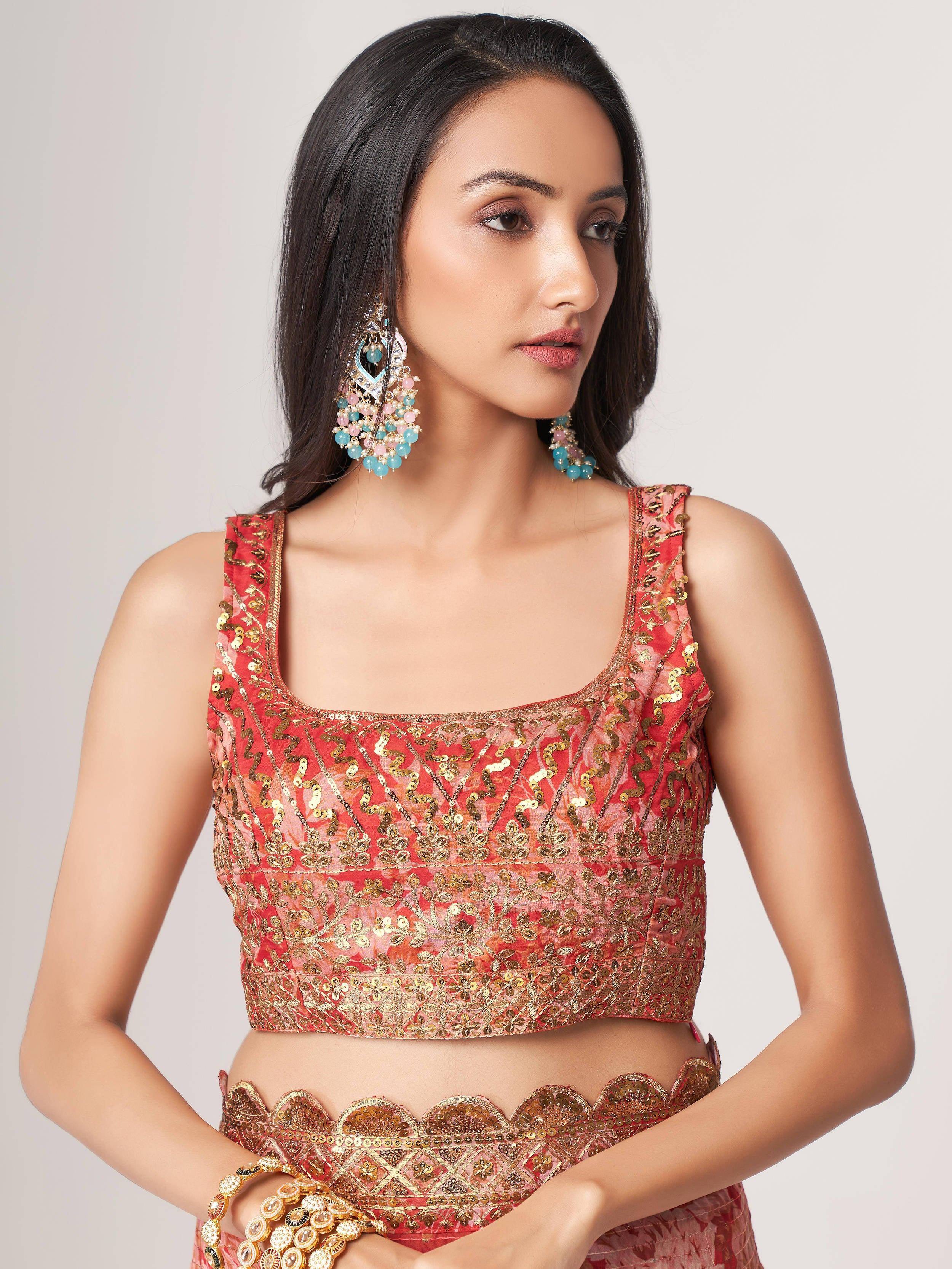 Pink and gold embroidered lehenga choli with sequins and statement earrings