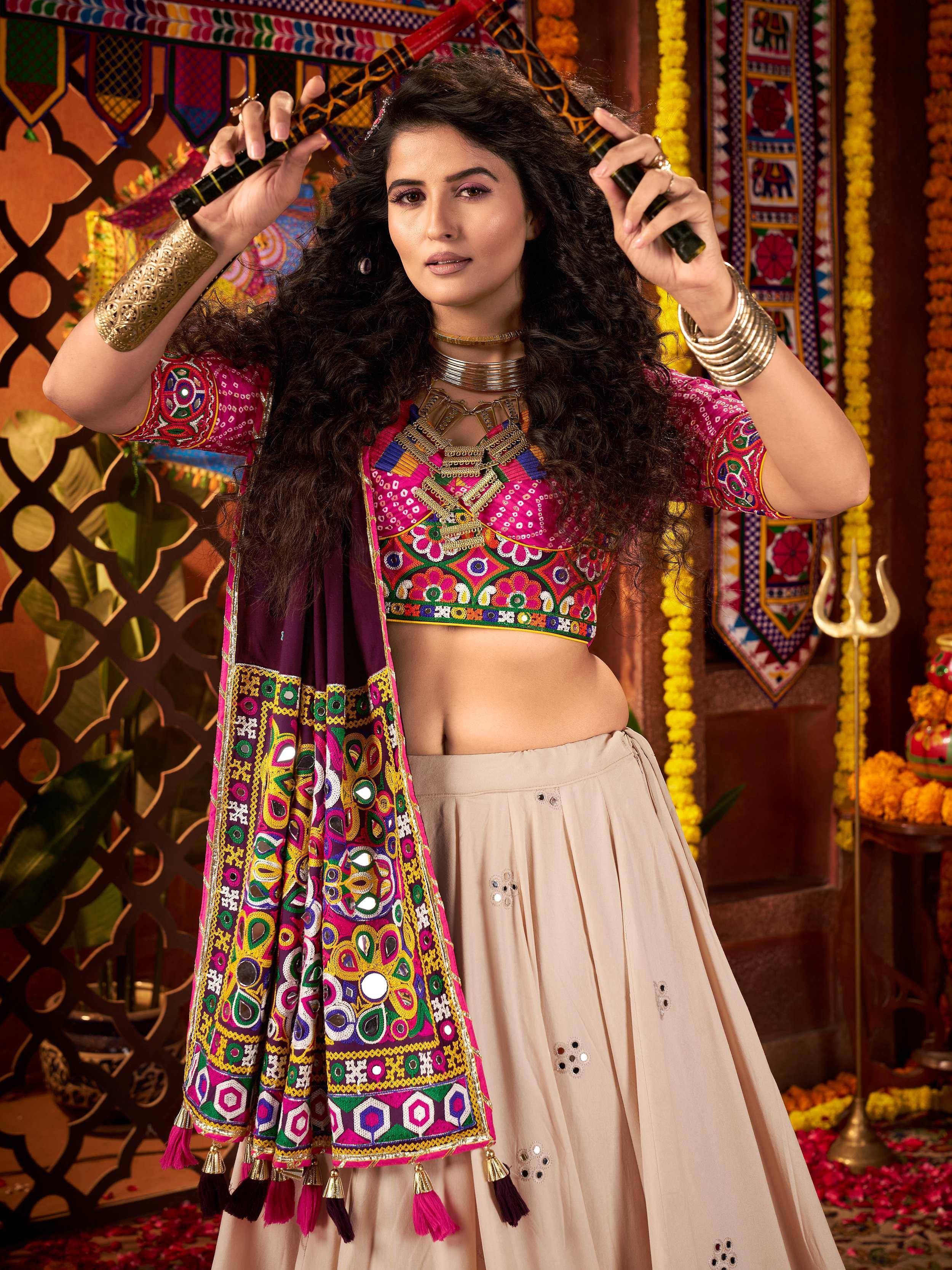 Vibrant Indian ethnic wear with embroidered blouse and mirror work dupatta, perfect for festive occasions.