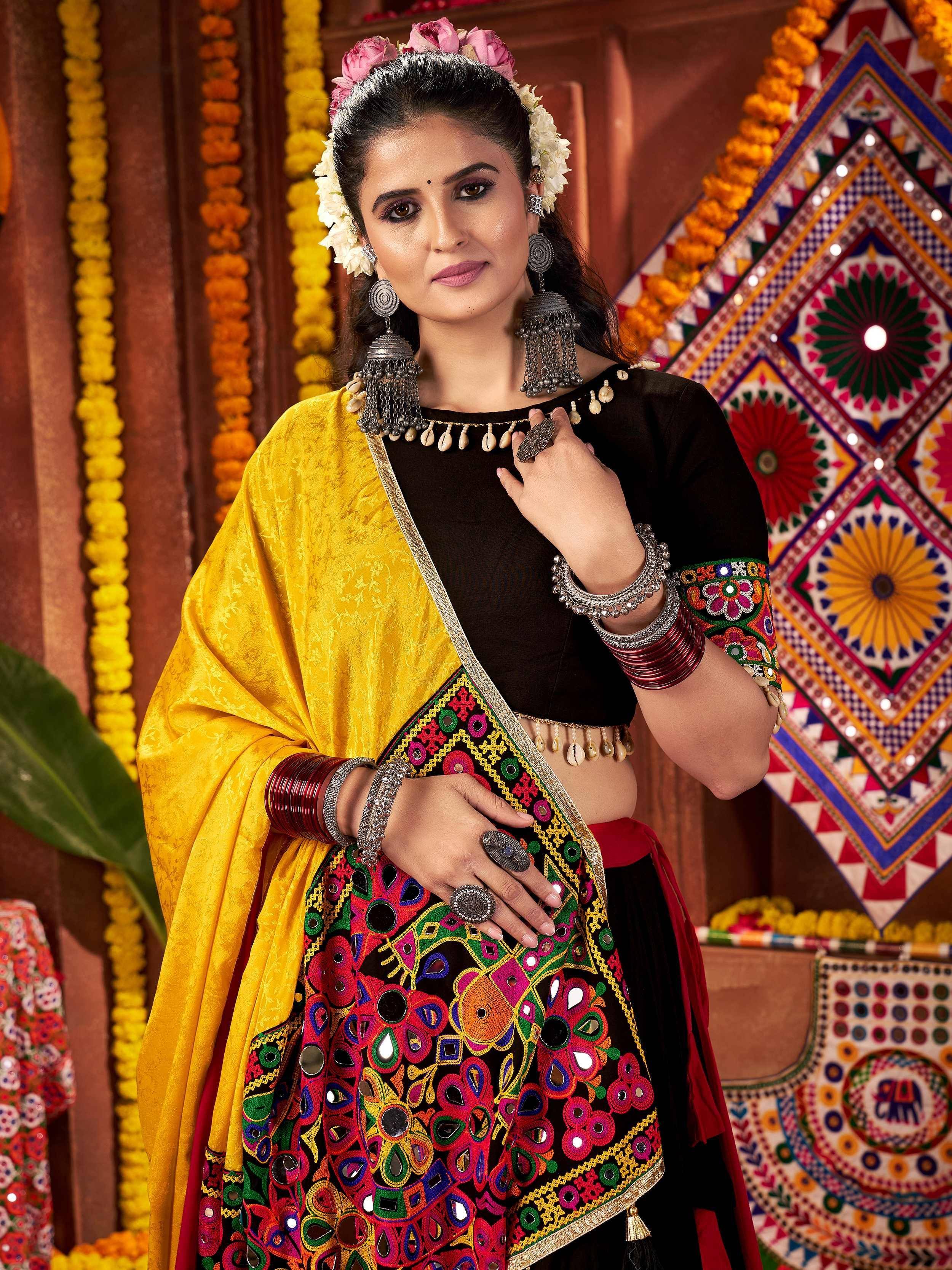 Vibrant Indian ethnic wear with mirror work, yellow dupatta, and floral hair accessories