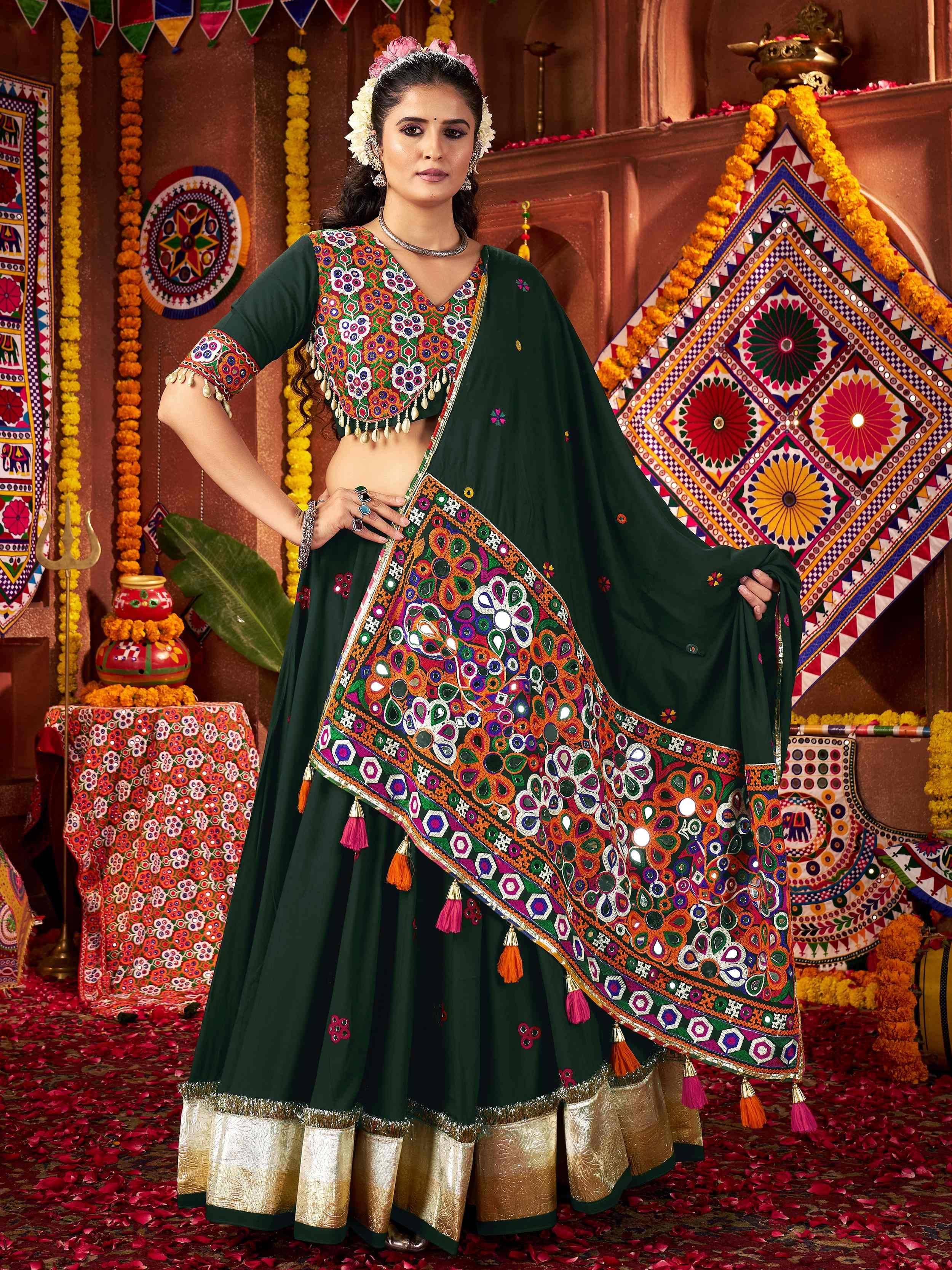 Green embroidered lehenga choli with mirror work and tassels, perfect for Indian ethnic wear