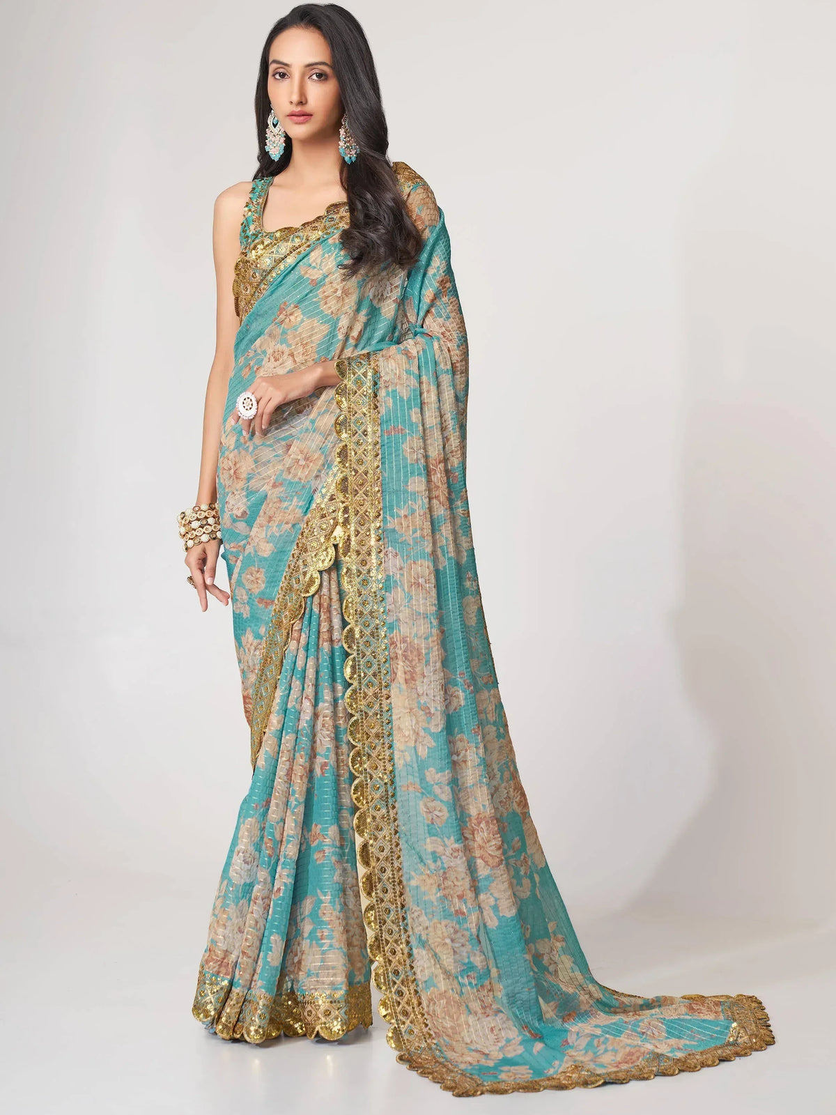 Teal and gold floral saree with intricate embroidery, perfect for Indian ethnic wear occasions.