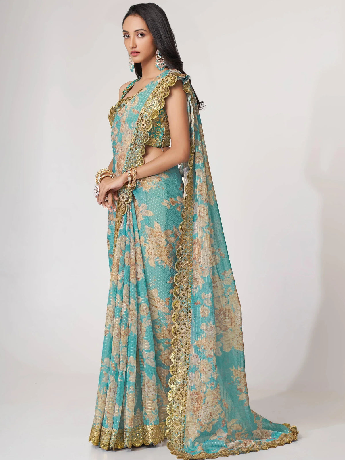 Teal and gold floral lehenga choli with scalloped embroidery, perfect for Indian ethnic wear occasions.