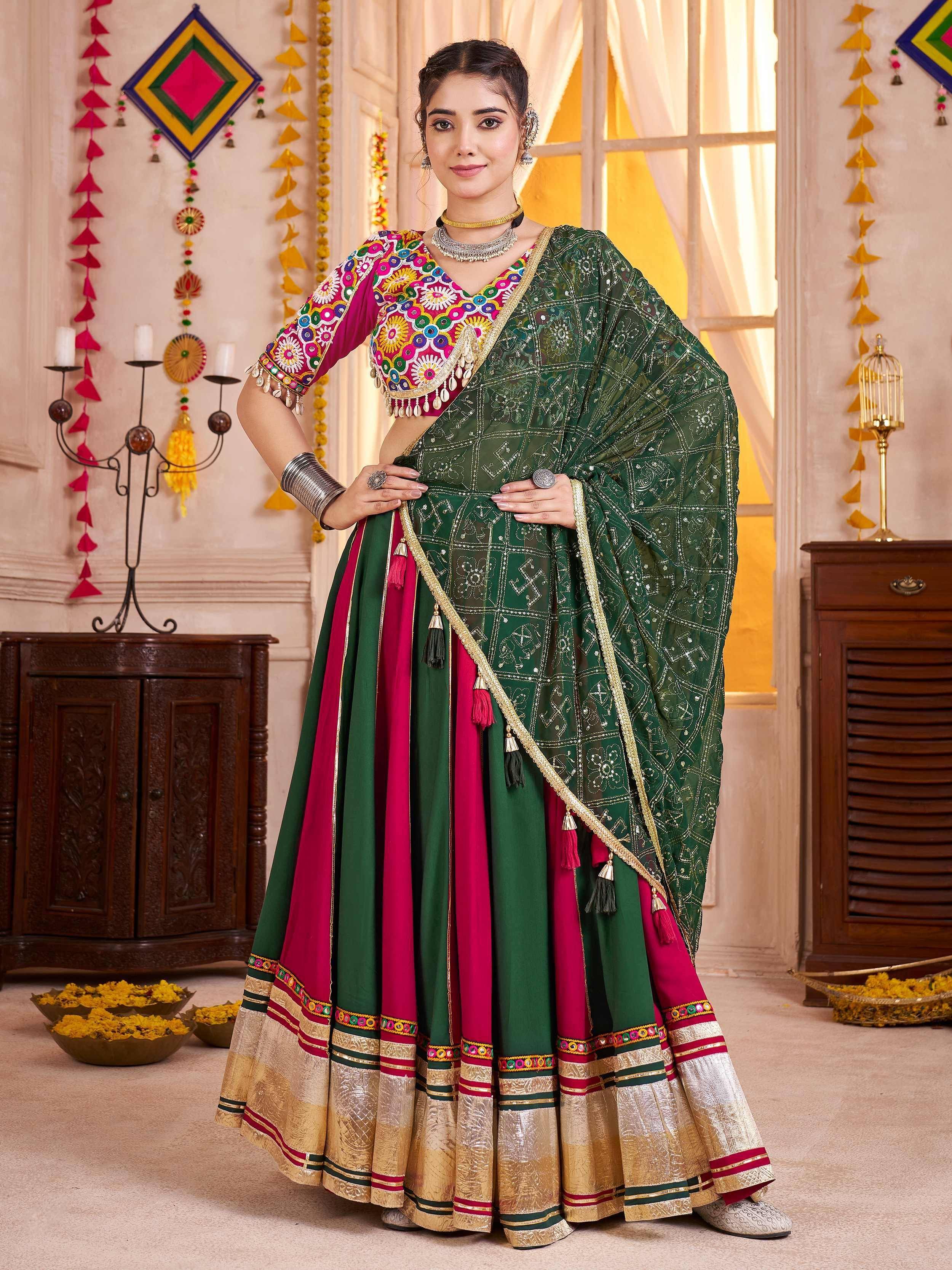 Green and pink embroidered lehenga choli with mirror work, perfect for Indian ethnic wear and festive occasions.