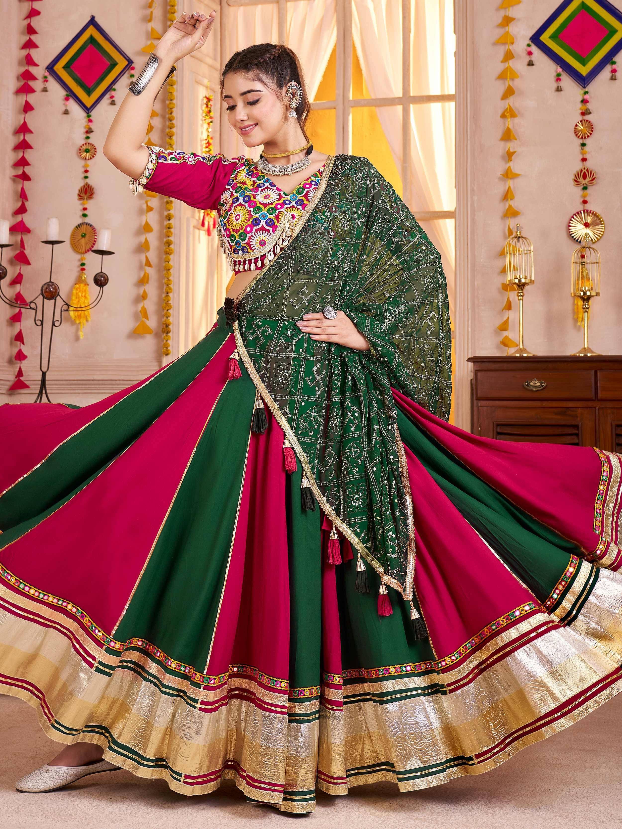 Elegant green and pink lehenga choli with intricate embroidery and golden borders, perfect for festive occasions.