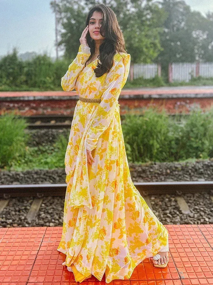 Yellow floral ethnic gown with belt, styled on railway platform for Indian wear fashion