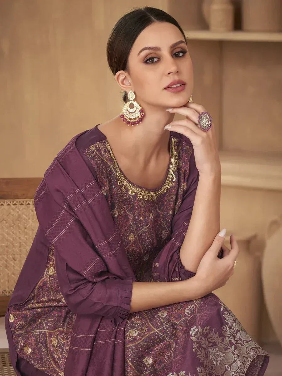 Elegant purple ethnic salwar kameez with gold embroidery, paired with statement earrings and ring.