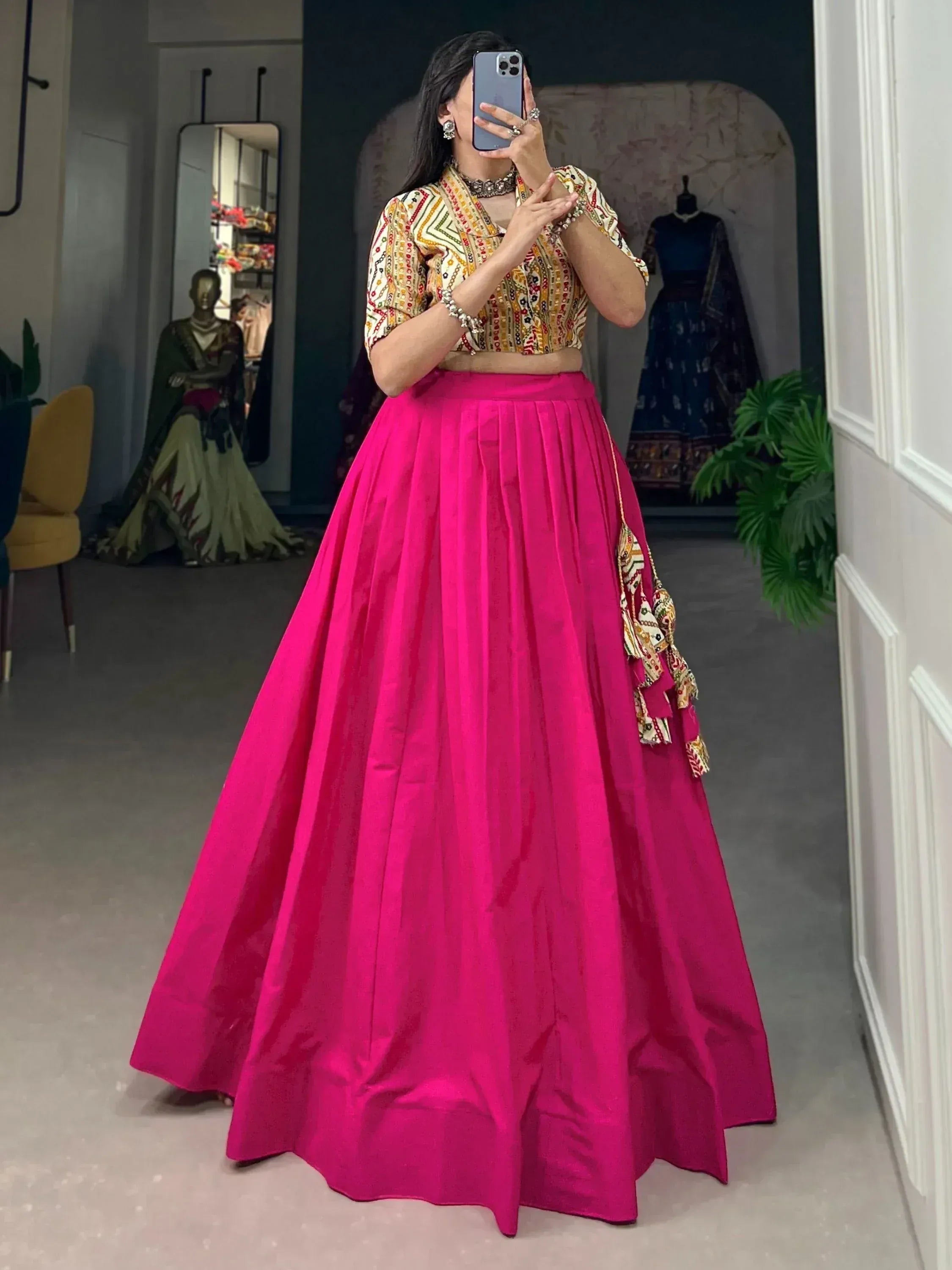 Woman in vibrant pink lehenga with embroidered blouse, perfect for Indian ethnic wear occasions