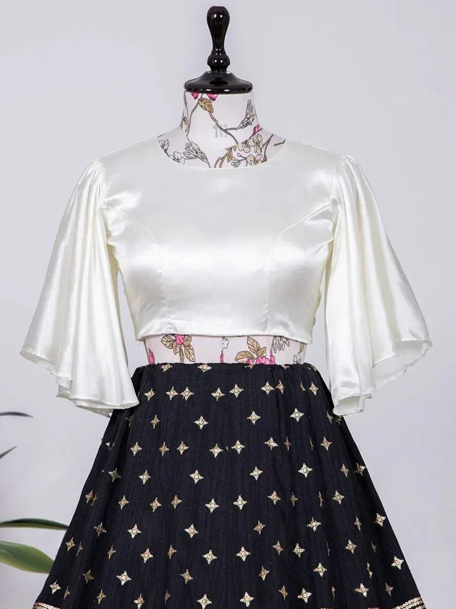 Elegant white satin blouse with bell sleeves paired with black embroidered lehenga skirt