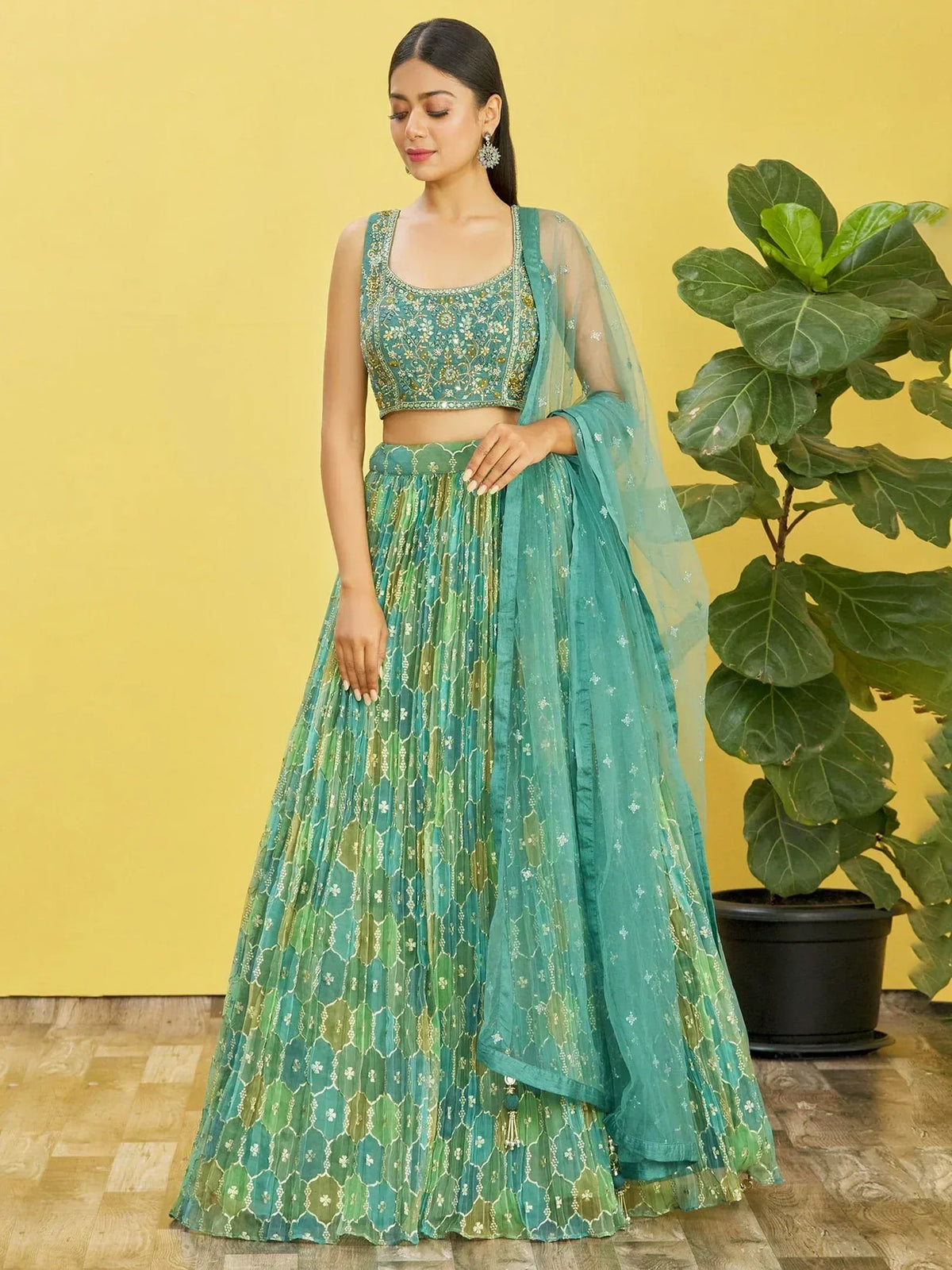 Teal embroidered lehenga choli with floral patterns and sheer dupatta, perfect for Indian ethnic wear