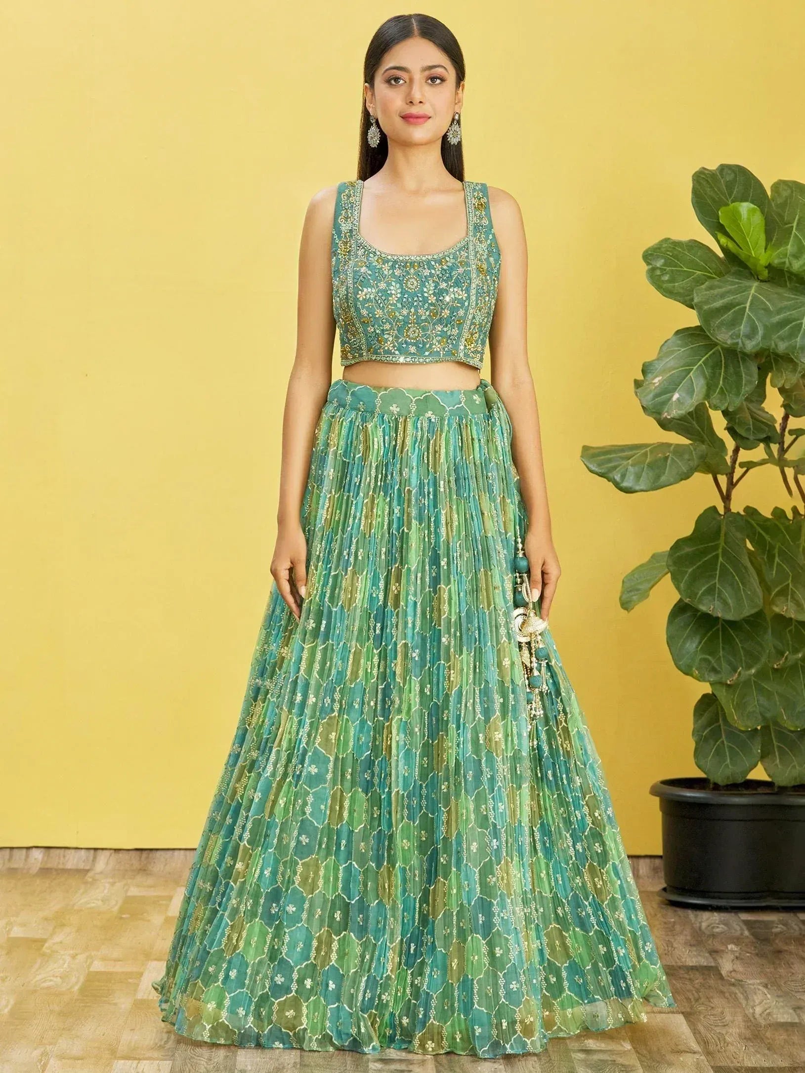 Green embroidered lehenga choli with floral patterns and pleated skirt for Indian ethnic wear