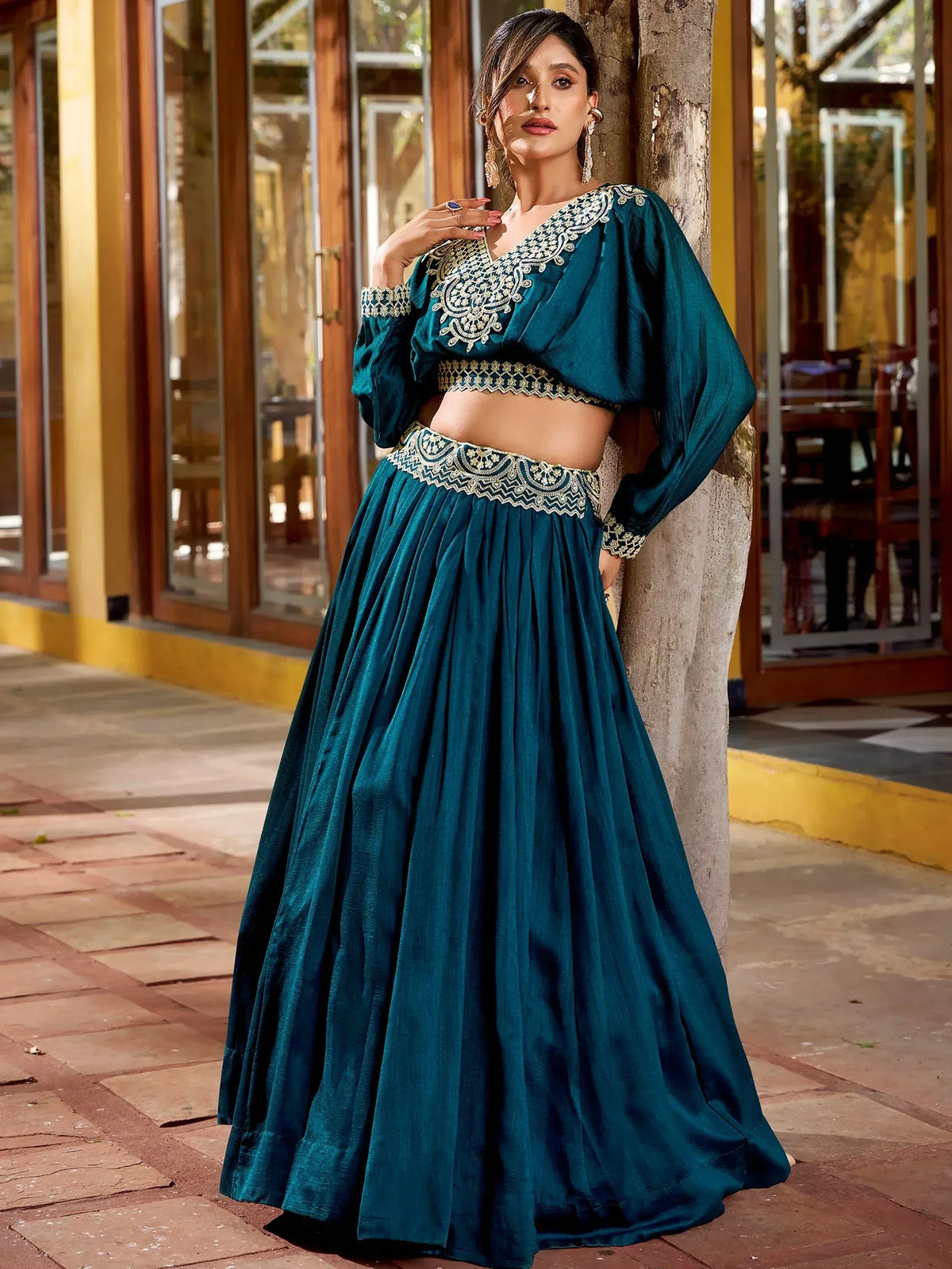 Teal designer lehenga choli with gold embroidery, perfect for Indian ethnic wear and festive occasions.