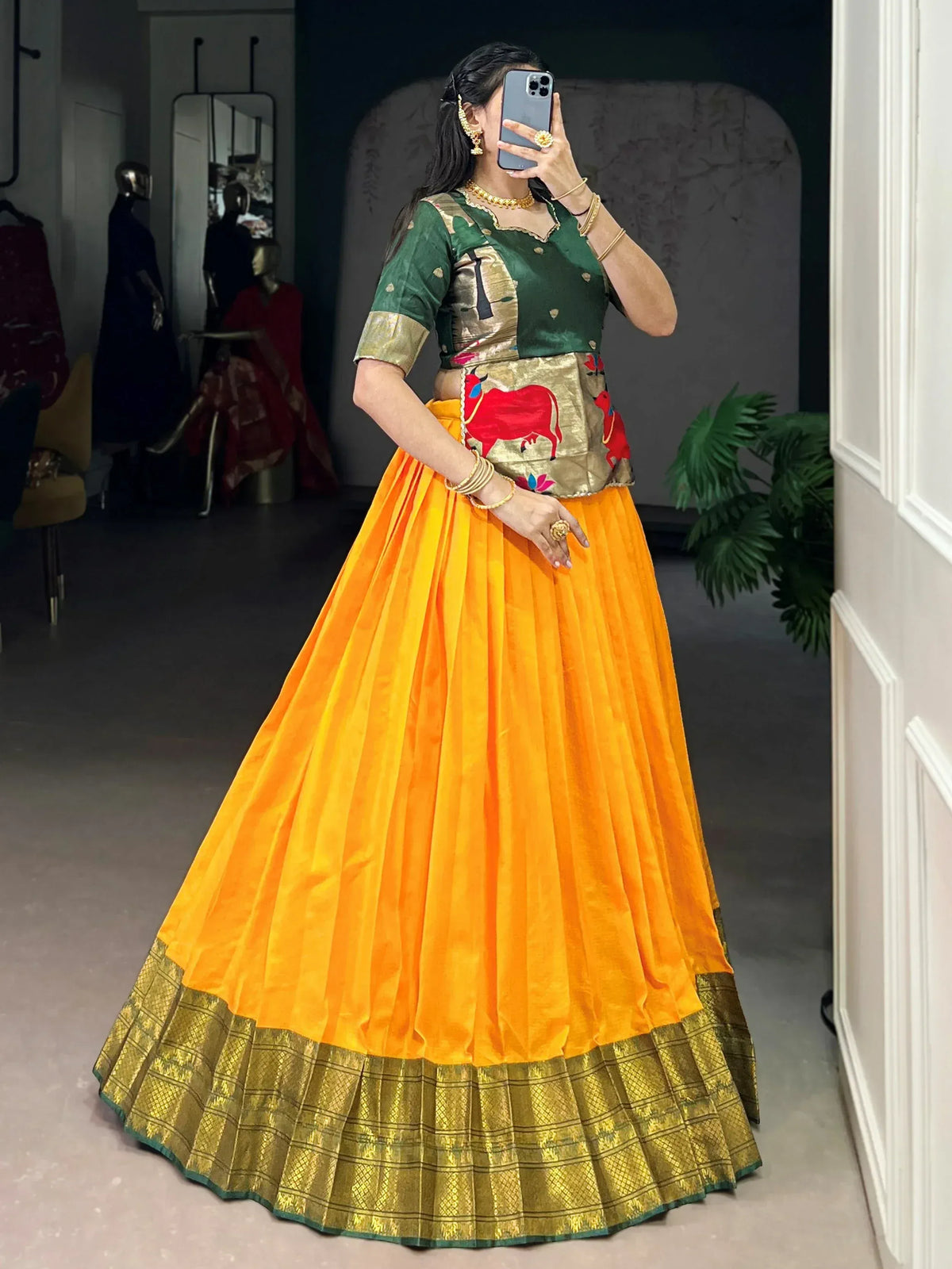 Vibrant orange lehenga with green blouse and gold border, perfect for Indian ethnic wear