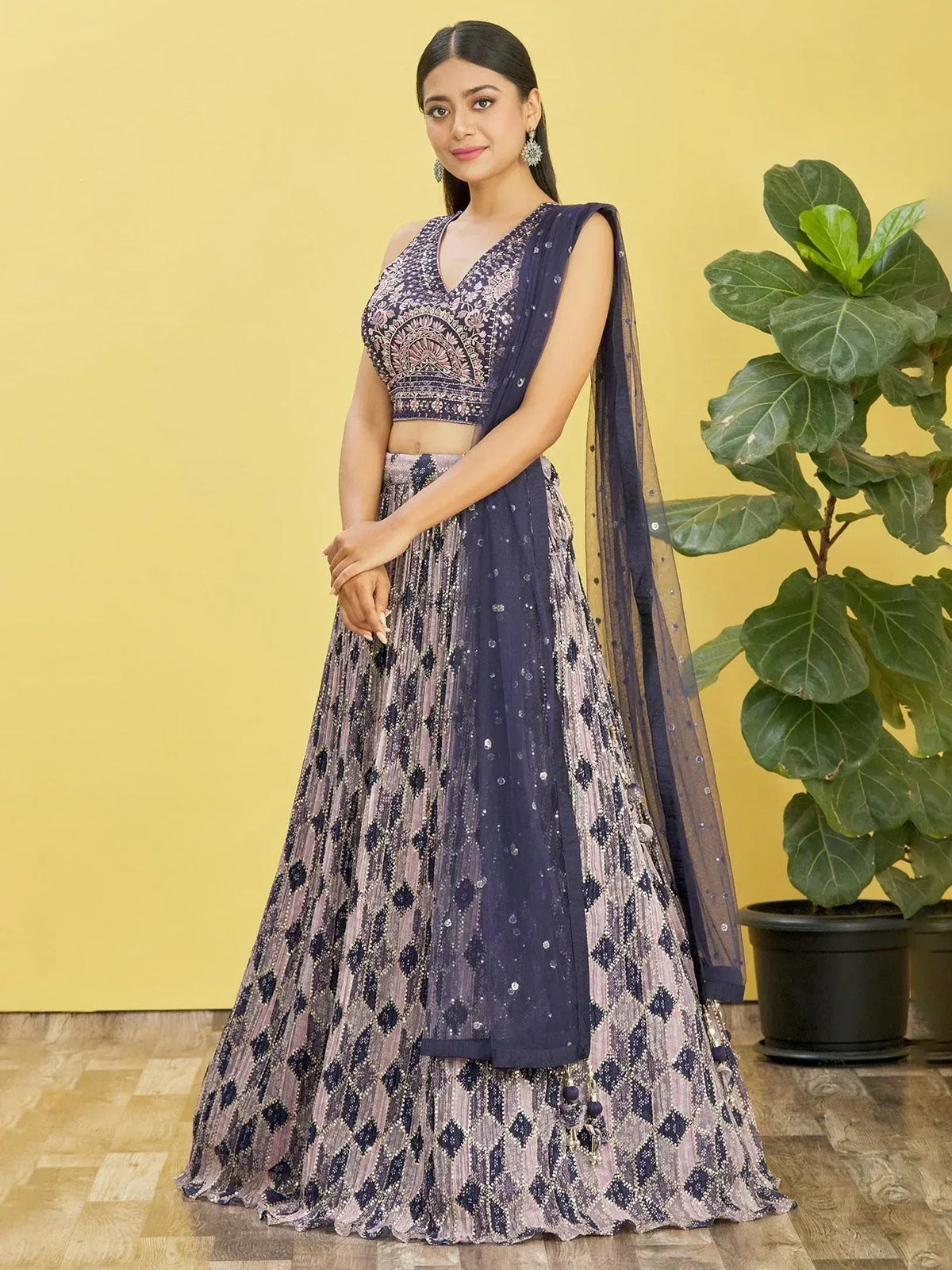 Elegant navy blue lehenga choli with intricate embroidery and sequin work, perfect for Indian ethnic occasions.