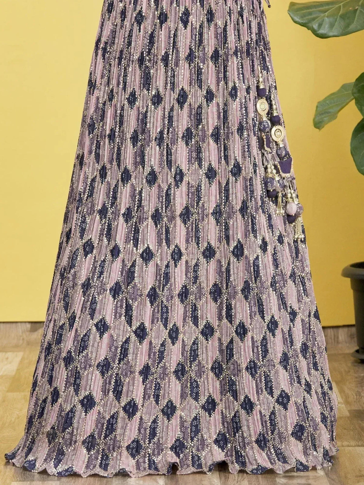 Pleated ethnic gown with diamond print and tassel detailing, perfect for Indian festive wear.