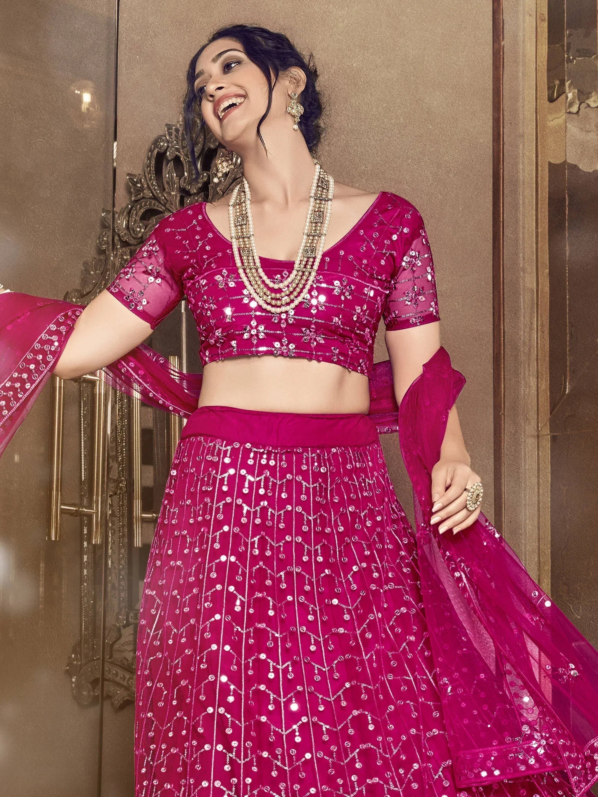 Fuchsia sequin lehenga choli with sheer sleeves, perfect for Indian weddings and festive occasions.