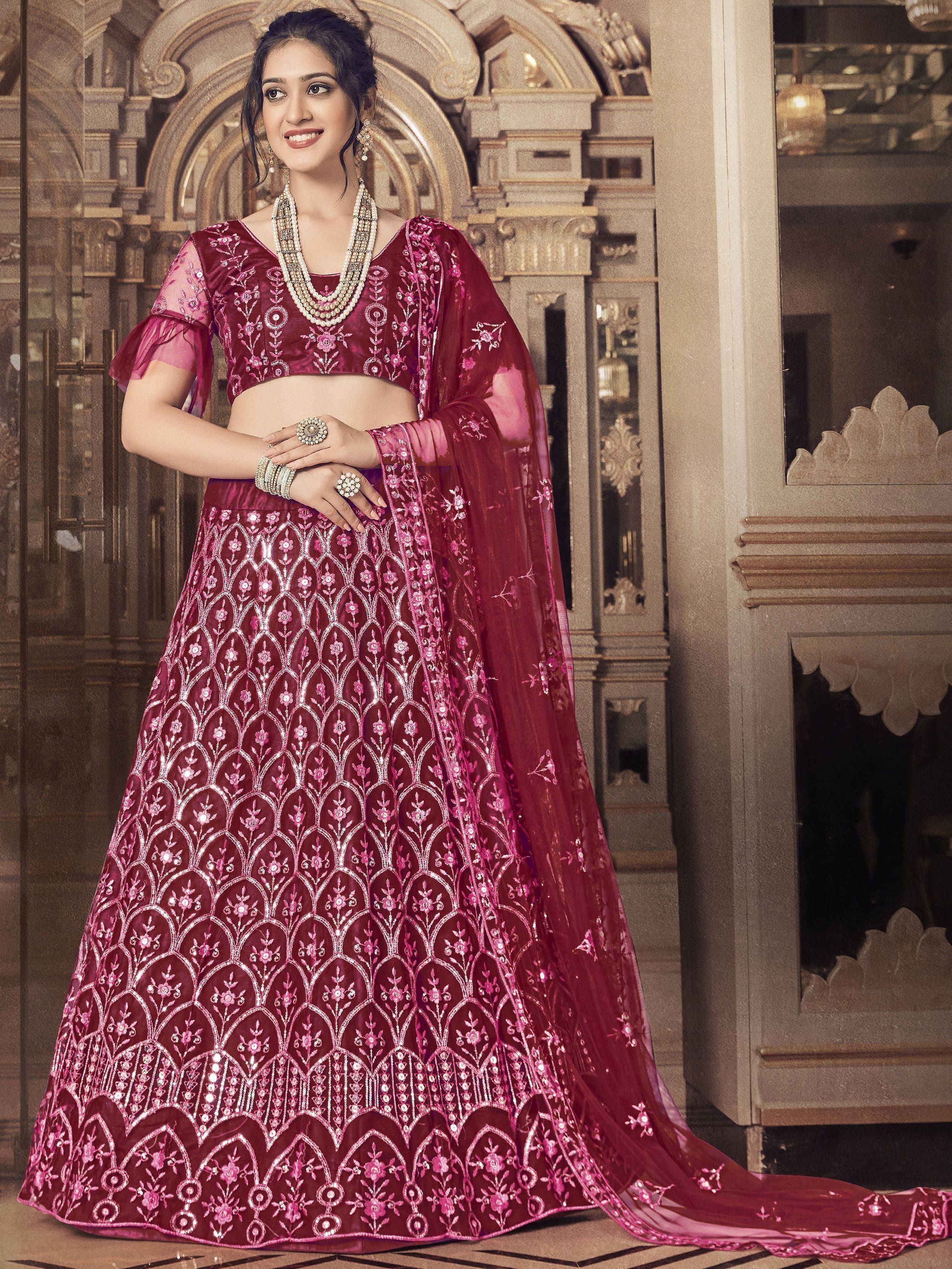 Elegant maroon lehenga choli with intricate floral embroidery and sheer dupatta, perfect for Indian weddings and festive occasions.