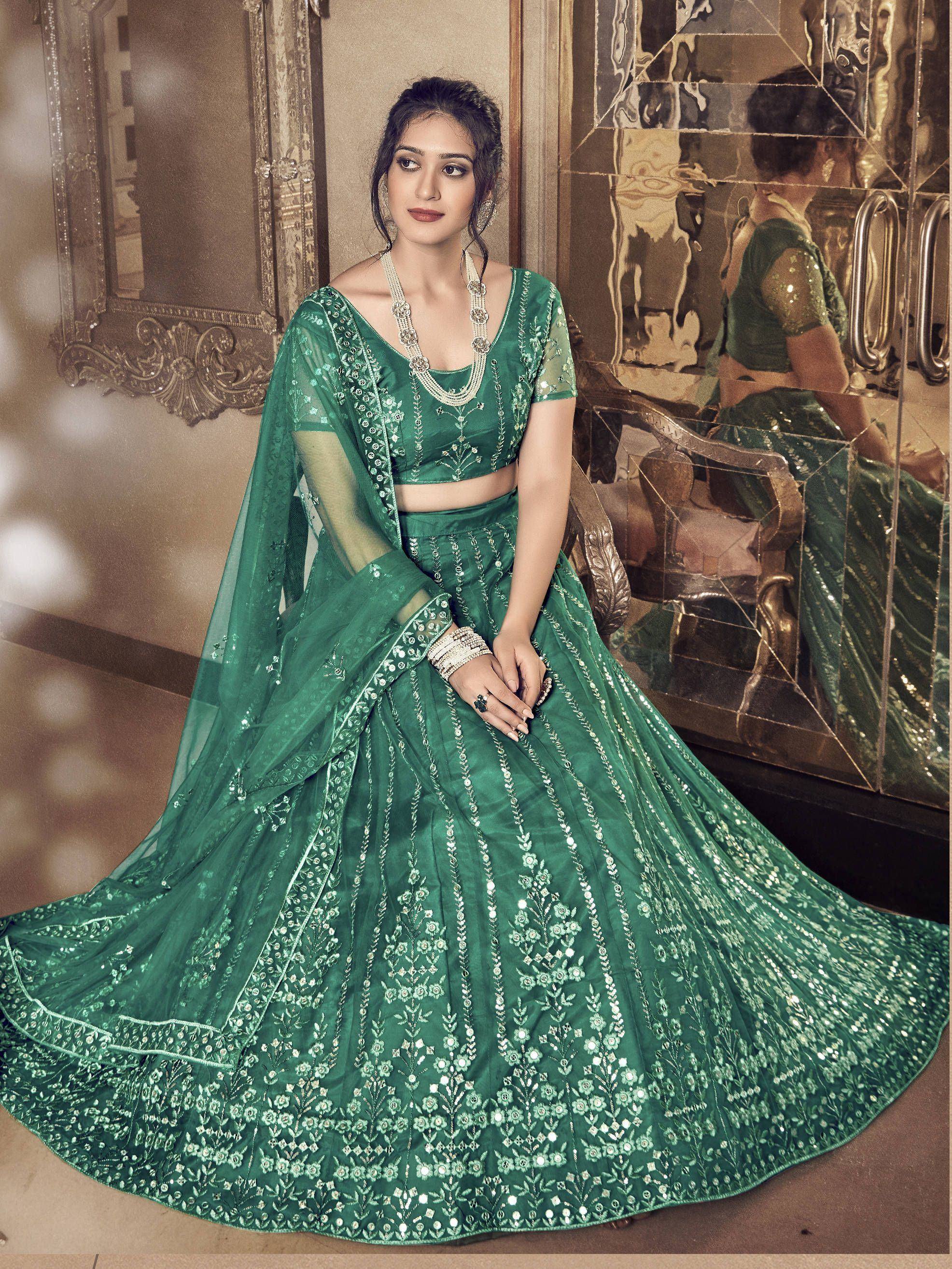 Emerald green designer lehenga choli with intricate floral embroidery and sequin work, perfect for weddings and festive occasions.