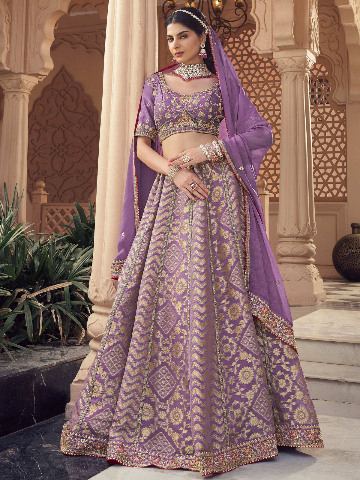 Purple embroidered lehenga choli with gold floral patterns, perfect for Indian weddings and festive occasions.