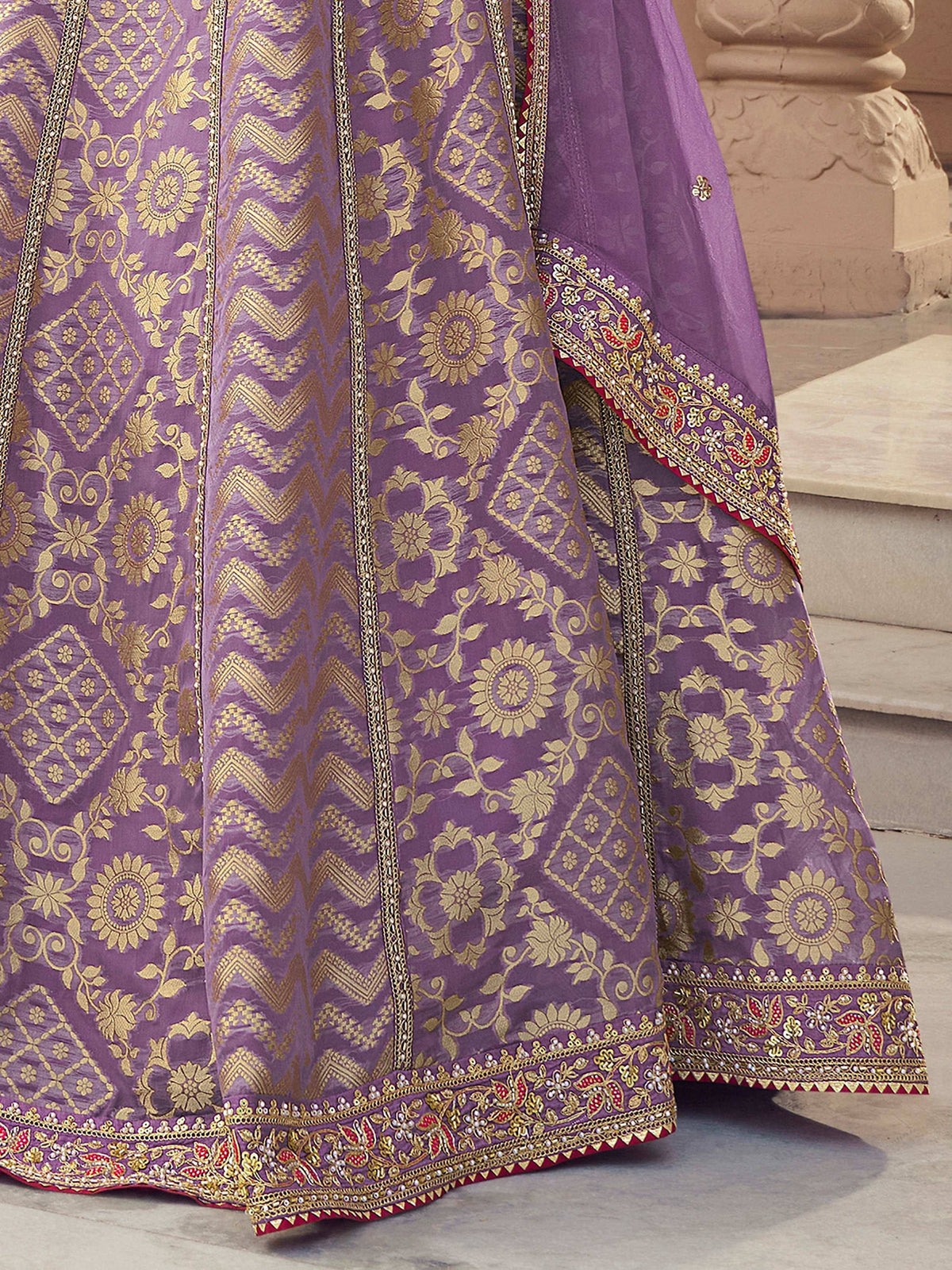 Purple designer lehenga with gold floral embroidery and intricate border detailing for Indian ethnic wear