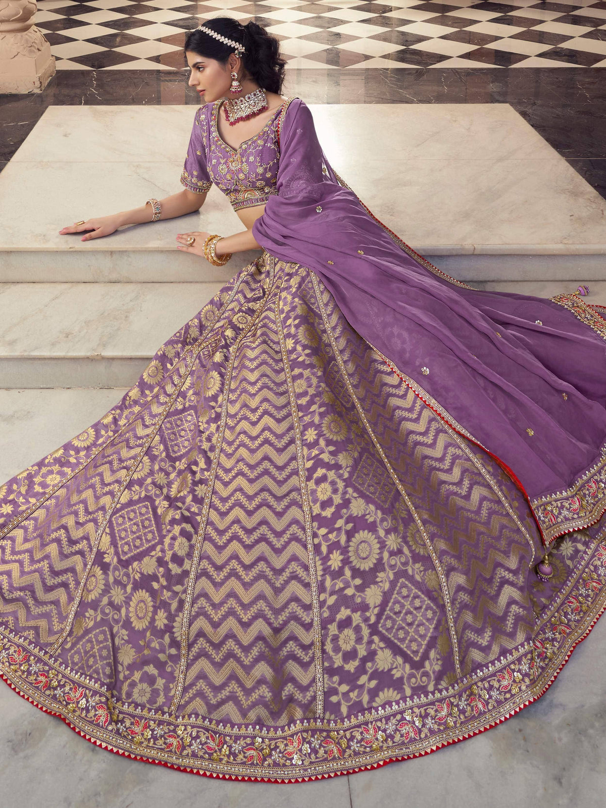 Purple designer lehenga choli with gold embroidery and floral patterns, perfect for Indian ethnic wear.
