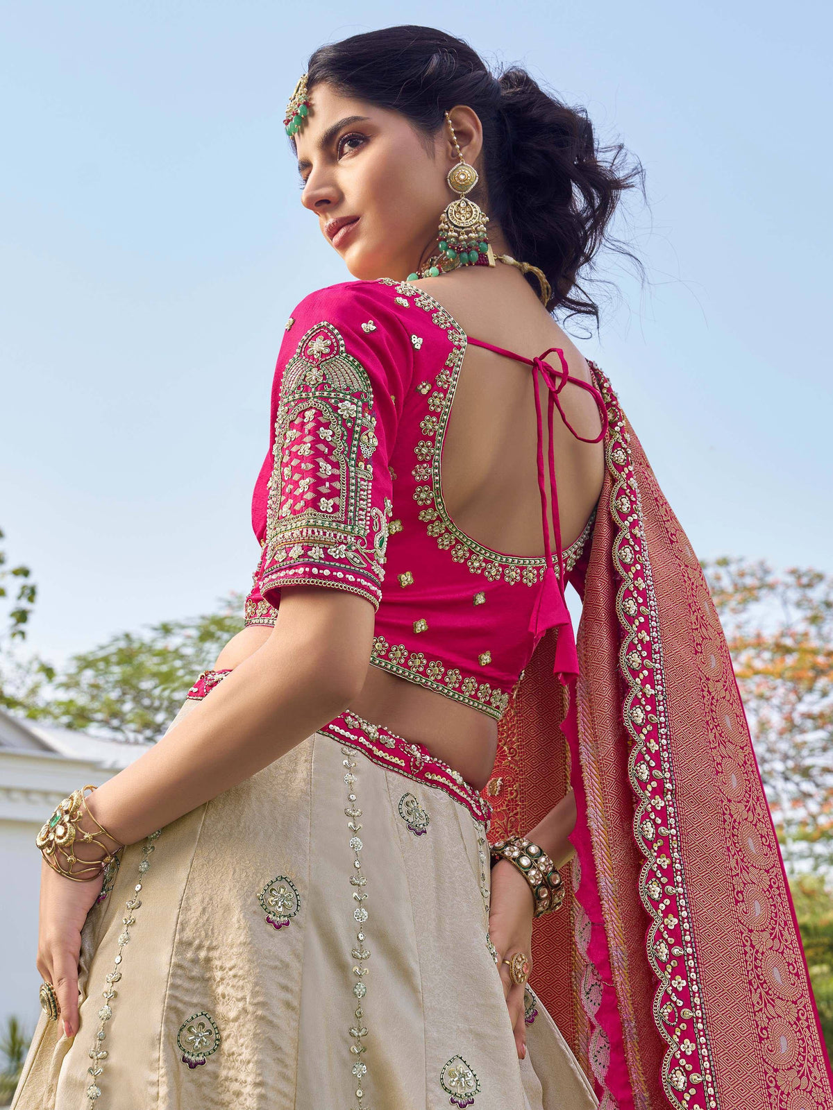 Pink embroidered lehenga choli with gold detailing, backless blouse, and matching dupatta for Indian ethnic wear