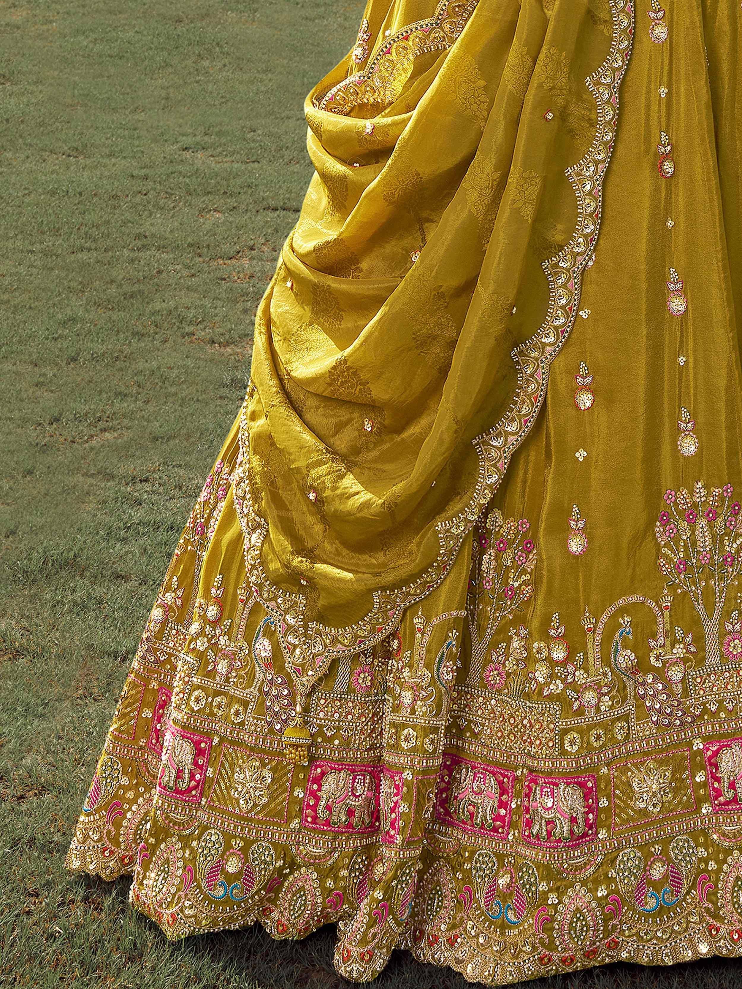 Yellow designer lehenga with pink and gold embroidery, featuring elephants and floral motifs