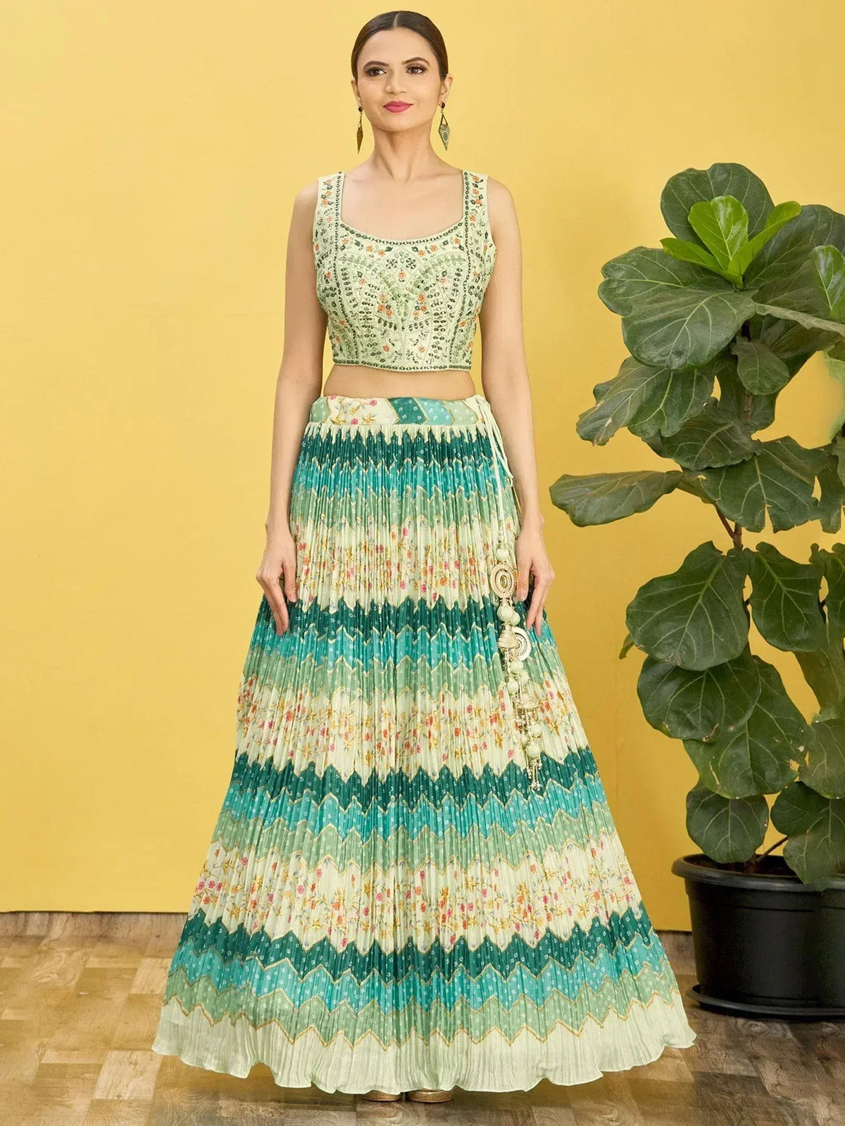 Woman in green floral embroidered crop top and pleated lehenga skirt, Indian ethnic wear