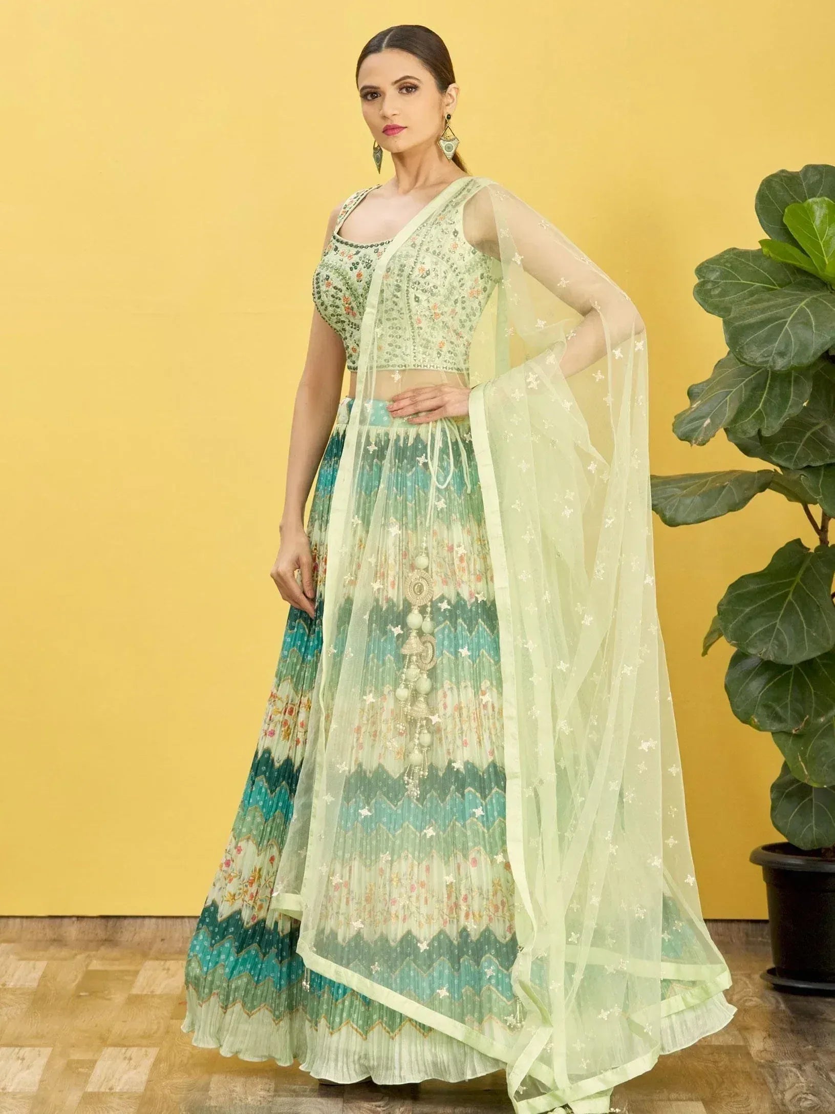 Mint green embroidered lehenga choli with floral print and sheer dupatta, perfect for Indian ethnic wear occasions.