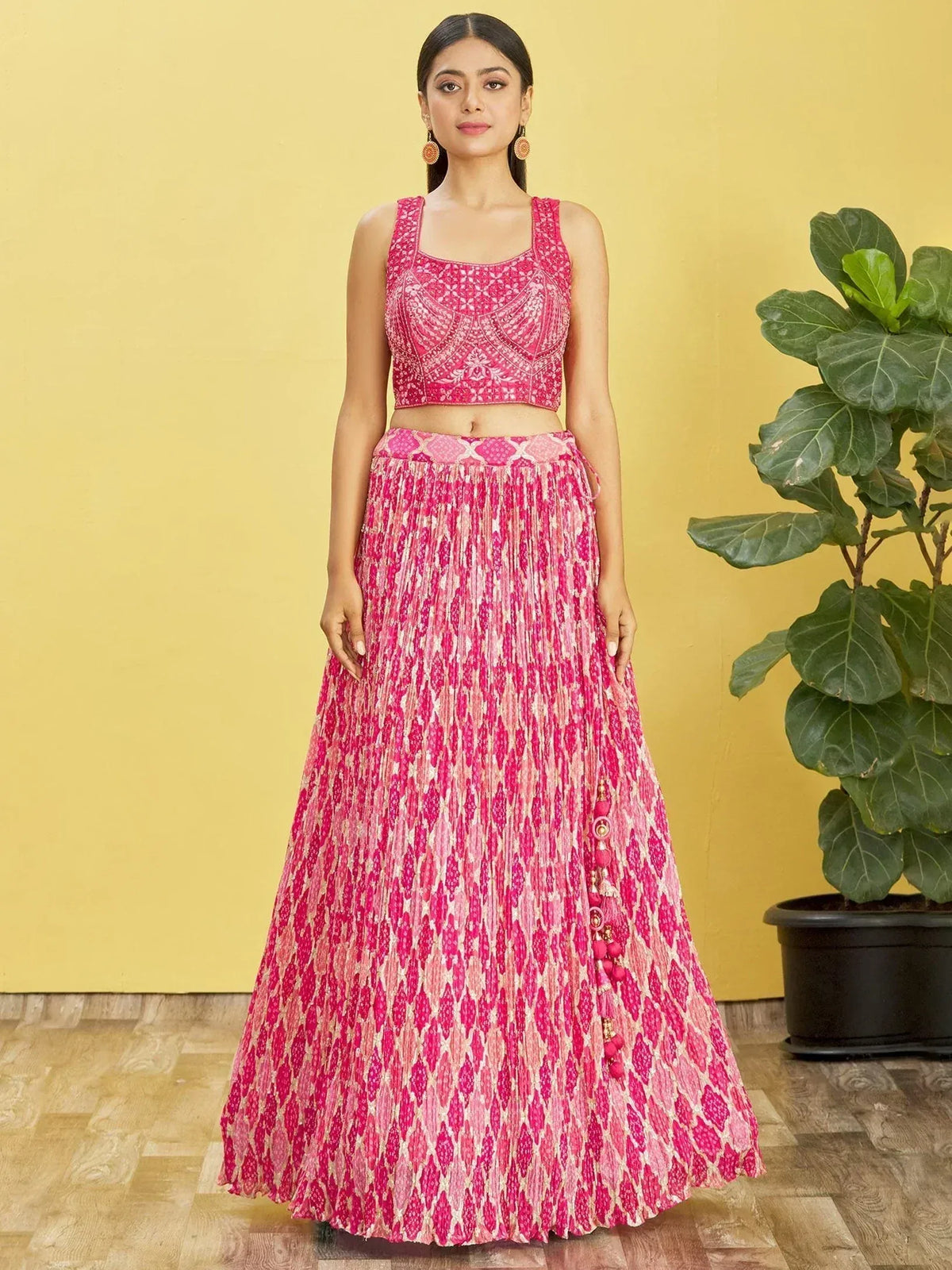 Pink printed lehenga choli with embroidered crop top and pleated skirt, ethnic Indian wear