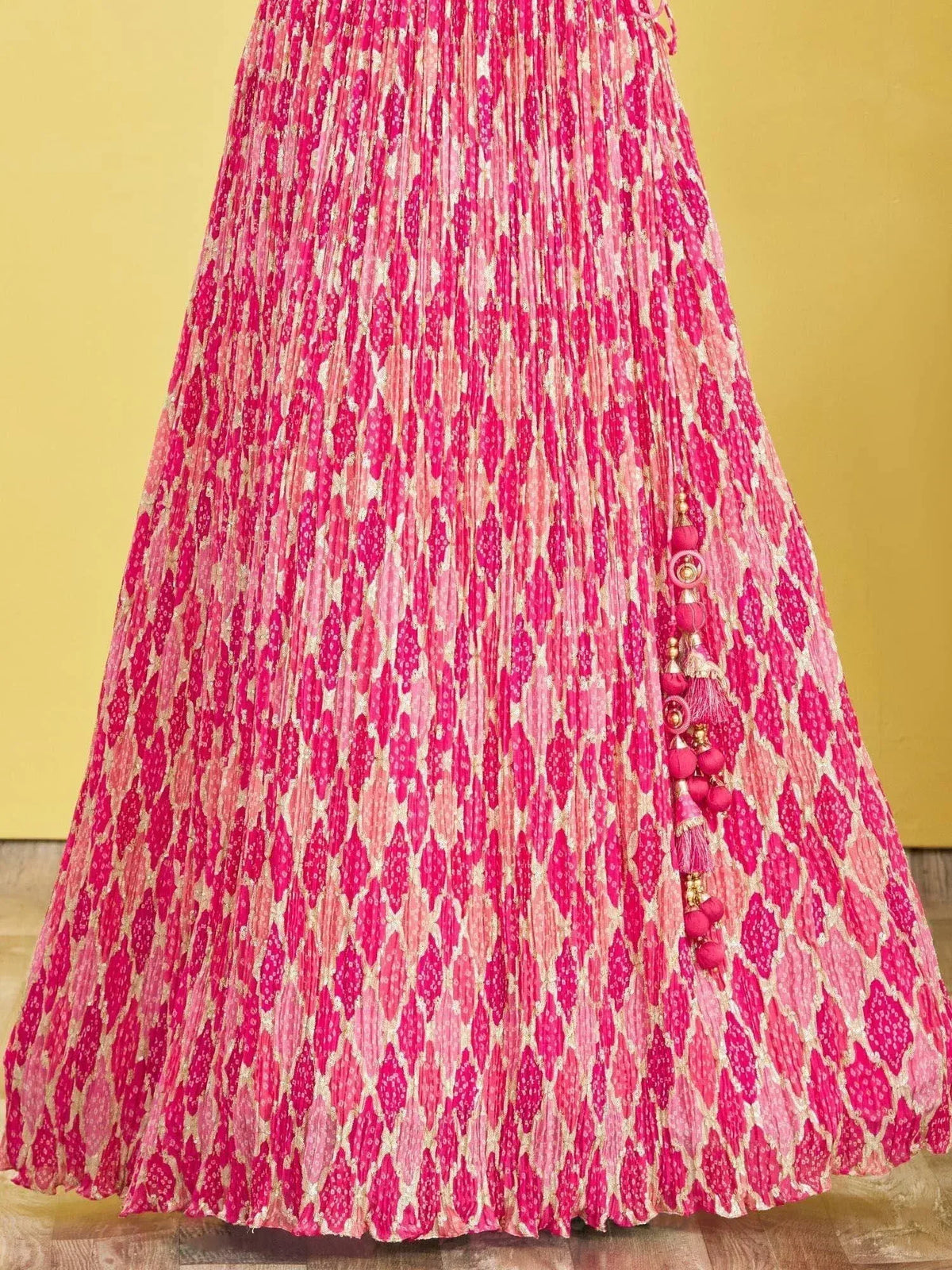 Pink pleated lehenga with gold geometric print and tassel detailing, ethnic Indian wear