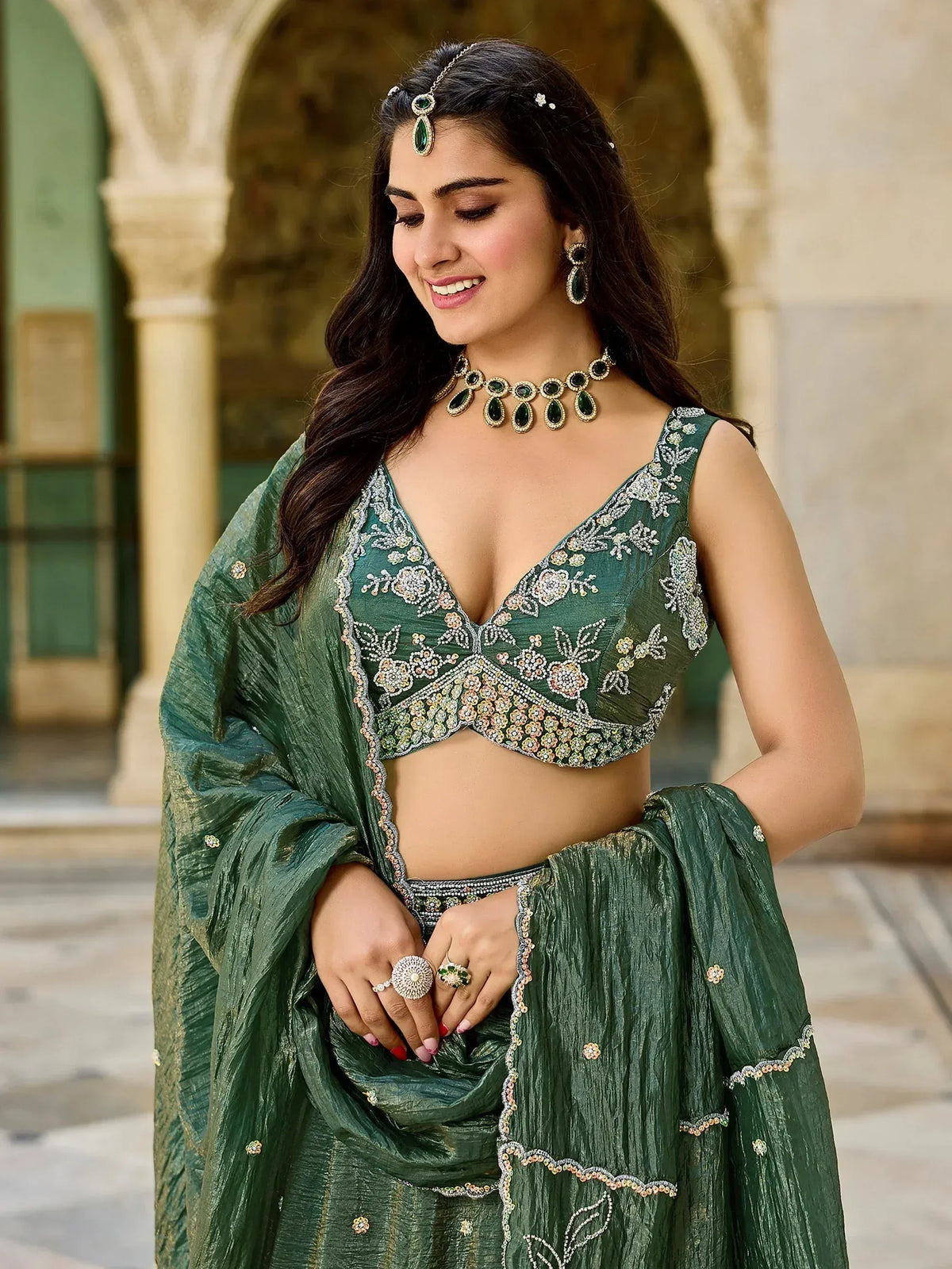 Emerald green embroidered lehenga choli with floral detailing, perfect for Indian ethnic wear occasions.
