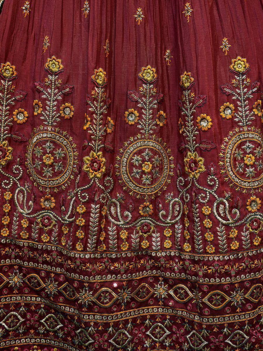Maroon lehenga with intricate floral embroidery and mirror work, perfect for Indian ethnic wear.