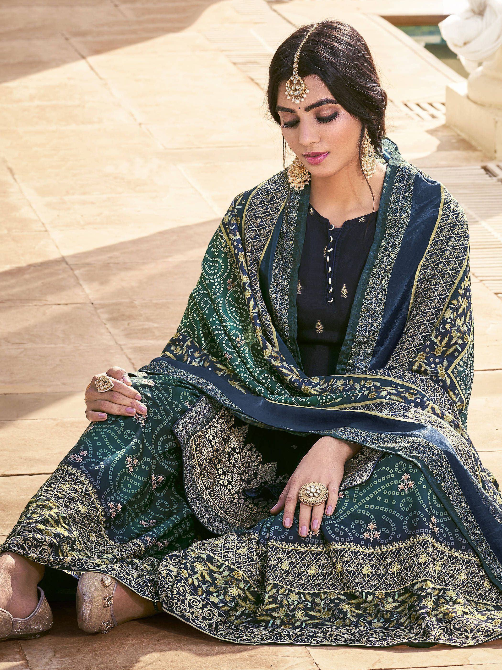Elegant Indian ethnic wear: dark green and navy printed salwar kameez with gold embroidery, perfect for festive occasions.