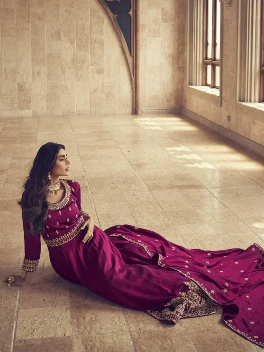 Elegant maroon ethnic gown with gold embroidery, perfect for Indian weddings and festive occasions.