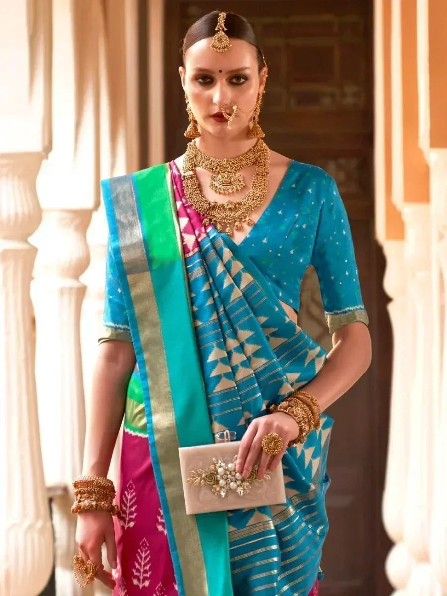 Woman in blue and pink ethnic saree with gold jewelry, traditional Indian wear for festive occasions