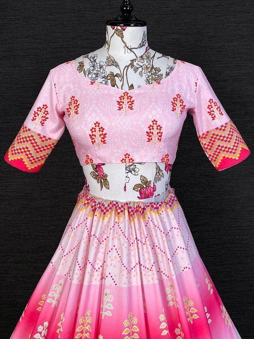 Pink floral ethnic gown with geometric patterns and vibrant sleeves, perfect for festive occasions.