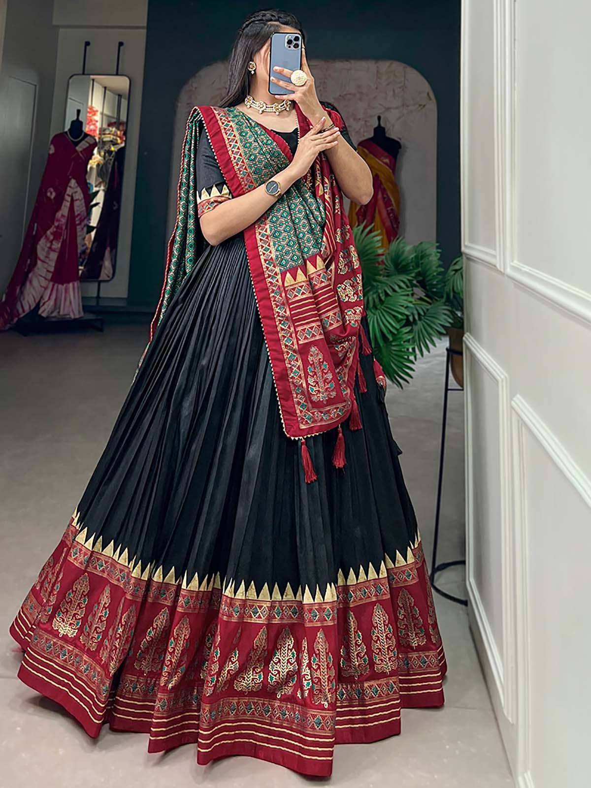 Black and red ethnic lehenga choli with intricate embroidery and pleated skirt, perfect for Indian festive occasions