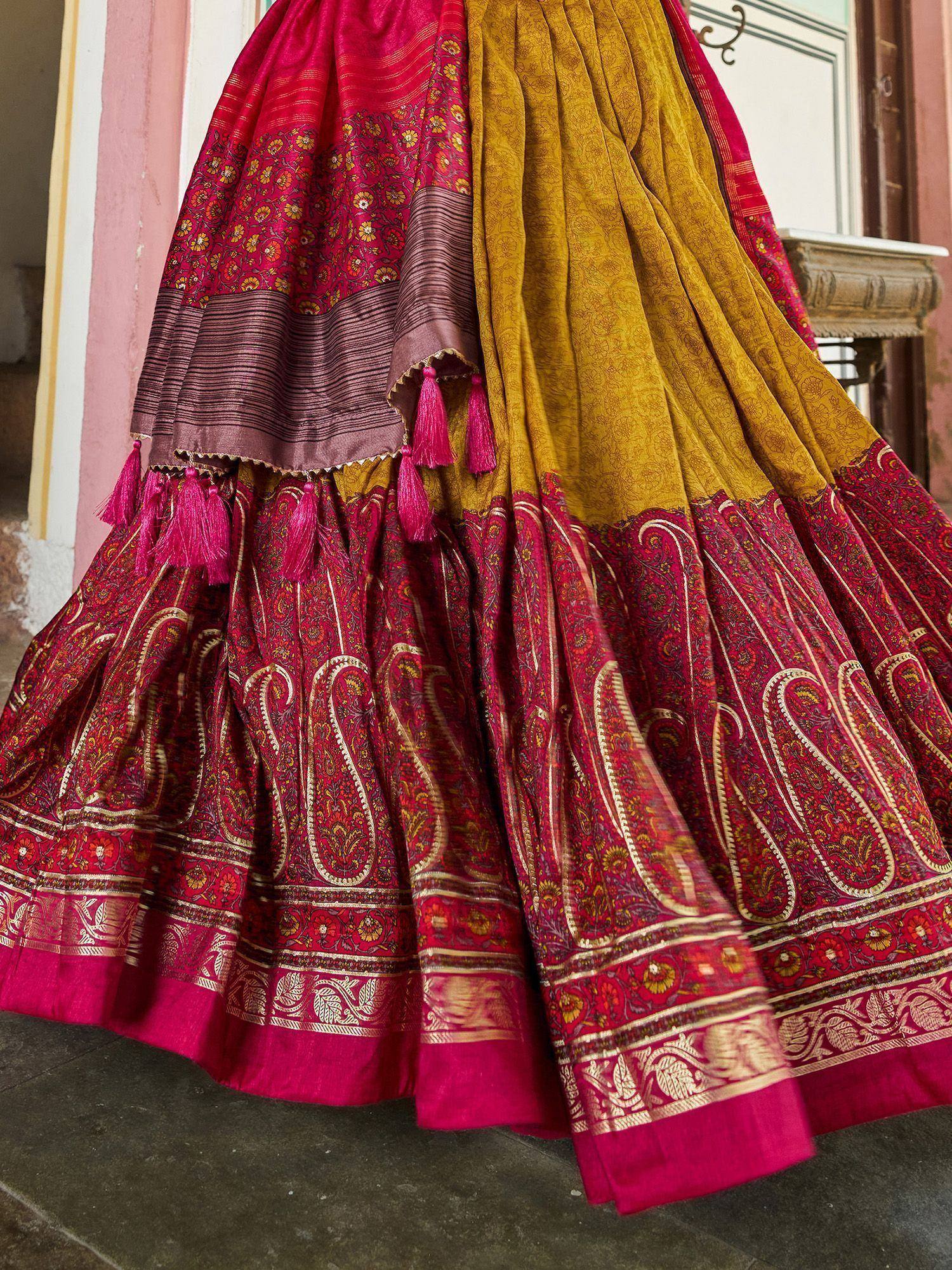 Vibrant red and gold ethnic lehenga with paisley print, tassels, and intricate border detailing