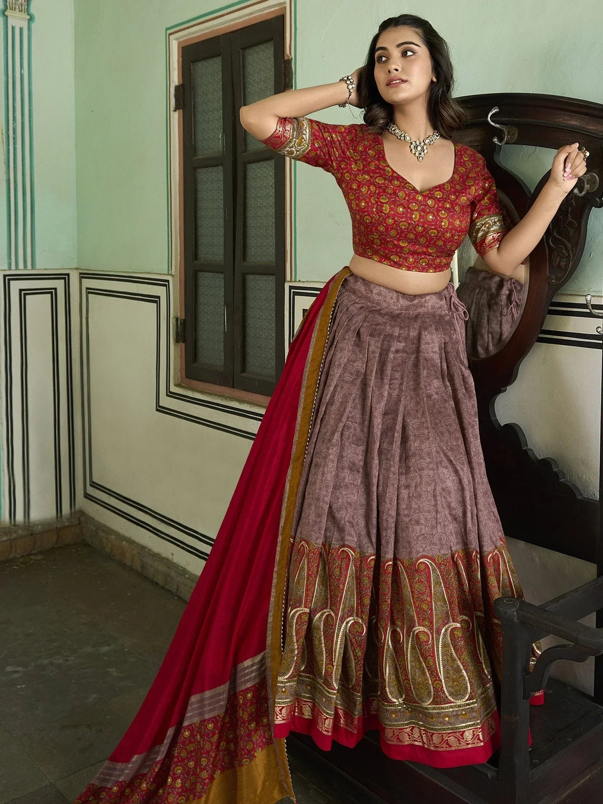 Red and mauve printed lehenga choli with gold embroidery, perfect for Indian ethnic wear occasions